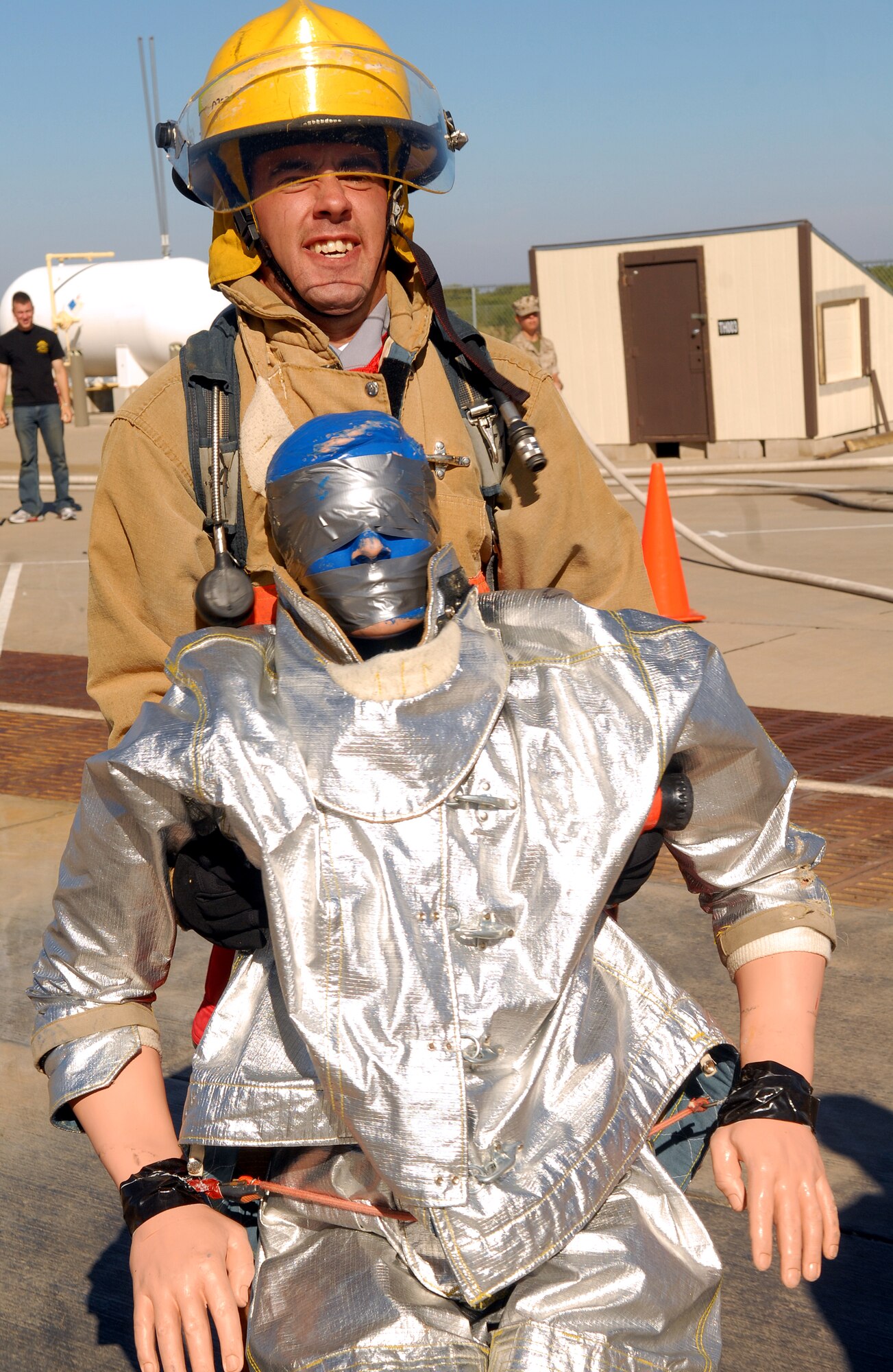 At left: Tech Sgt. Edward Struckel, a member of the Super Wings Rookie Fire Fighter Challenge team, drags a 175-pound dummy 100 feet toward the finish line at the Rookie Challenge Oct. 20. (U.S. Air Force photo by Airman 1st Class Kamaile Chan)