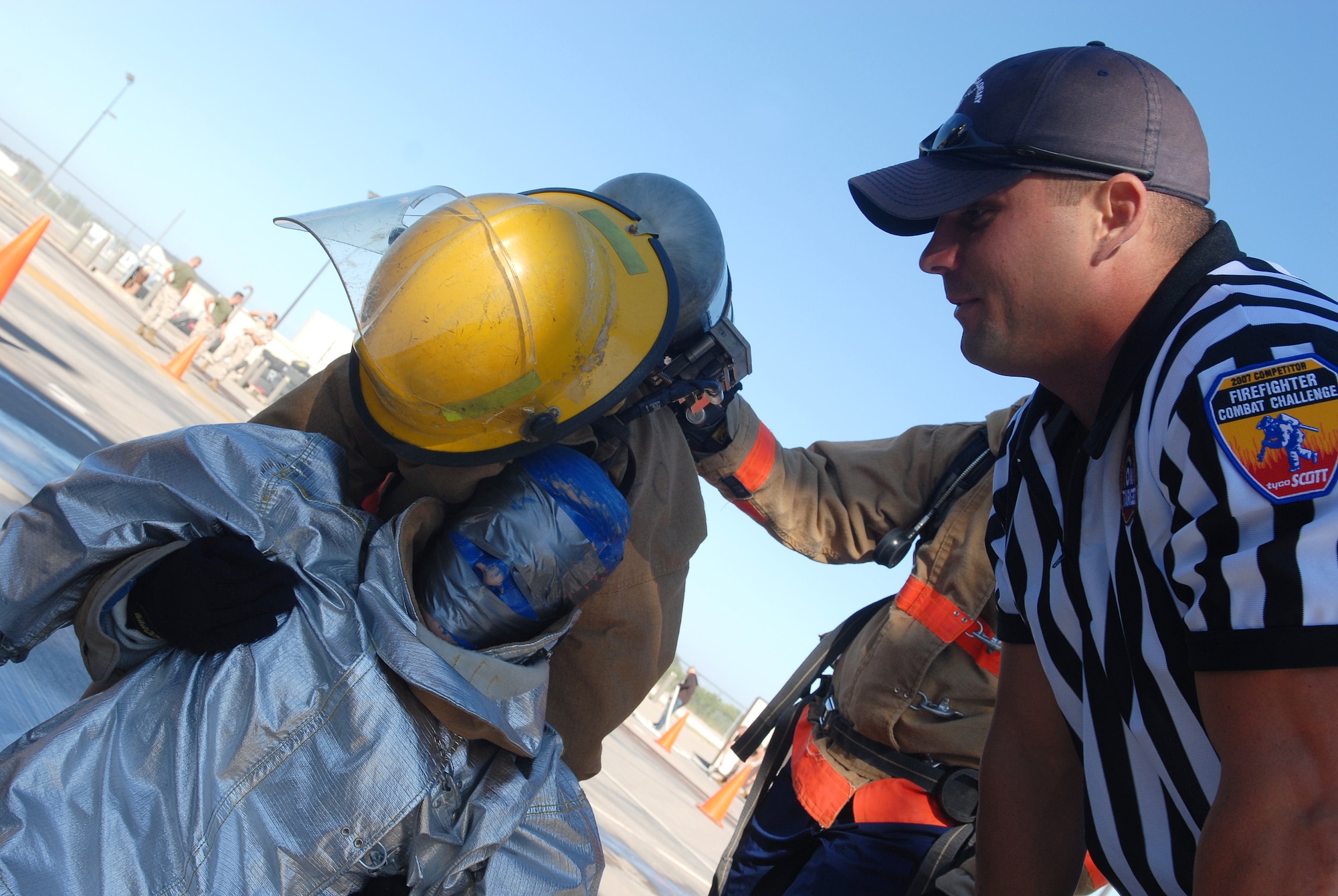 Above: Marine Staff Sgt. Nicholas Cook, a member of the SAM Squad Fire Fighter Combat Challenge team and co-event coordinator gives advice to a participant during the dummy-drag portion of the Rookie Challenge Oct. 20. (U.S. Air Force photo by Airman 1st Class Kamaile Chan)