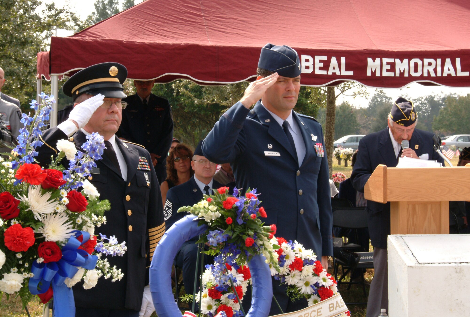Col. Ken Wilsbach, 53d Wing commander, and retired Army First Sgt. Tom Rice, salute as the names of 35 fallen veterans from Eglin Air Force Base are called out during the placement of a wreath at the Beal Memorial Cemetery Veterans Day ceremony in Fort Walton Beach, Fla. Nov. 12.  Colonel Wilsbach spoke about reflecting on the foresight, courage and sacrifices of past leaders and heroes and to remember the courage and sacrifices of today’s men and women in the military to a crowd of nearly 300. The ceremony was concluded with a 21-gun salute, playing of taps by the Eglin Honor Guard and an F-16 missing man formation fly-over by the 85th Test and Evaluation Squadron. (U.S. Air Force photo/ Tech. Sgt. Andrew Leonhard)