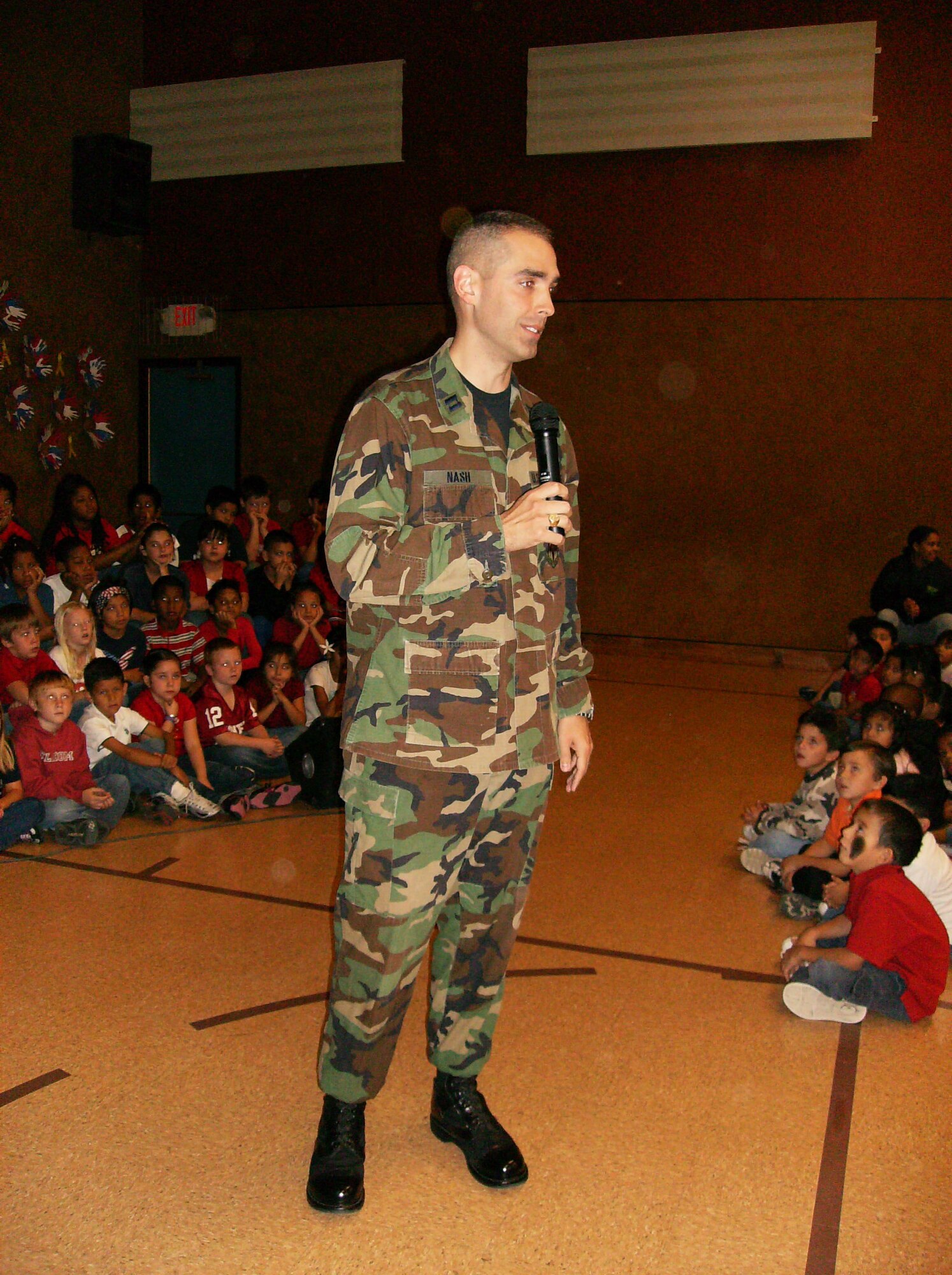Chaplain (Capt.) Zachary Nash, 71st Flying Training Wing Protestant chaplain, speaks to more than 300 students about Veterans Day Nov. 9 at Coolidge Elementary School in Enid, Okla.  Approximately 40 Coolidge students have parents deployed to Iraq. (Courtesy photo)