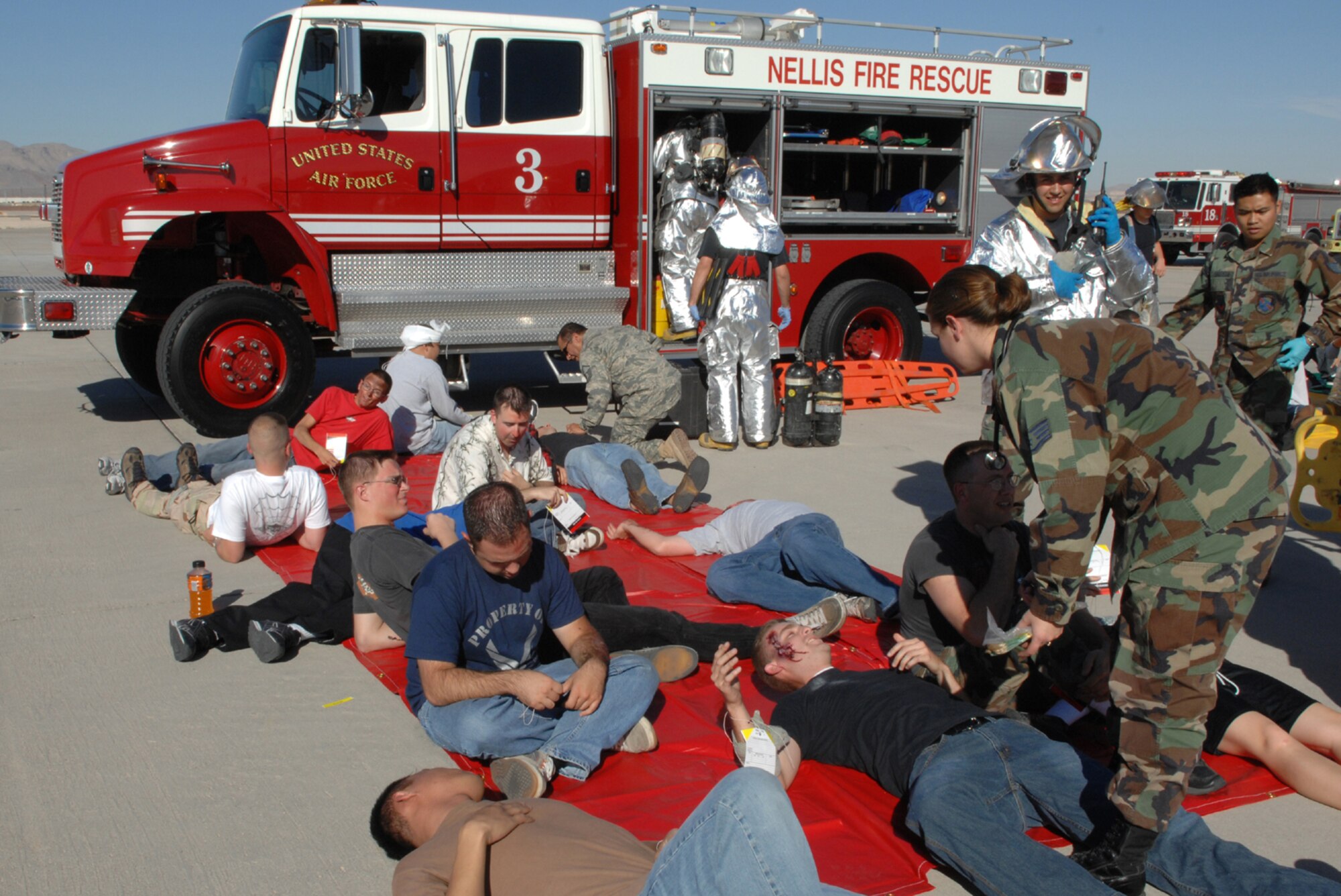 First responders and medical personnel tend to "victims" during a major accident response exercise here Nov. 5. The exercise, held in preparation for Nellis'  air show, gave Nellis Airmen a chance to sharpen emergency response skills in the event of a mass casualty incident. (U.S. Air Force photo by Airman 1st Class Kasabyan D. McGarvey)