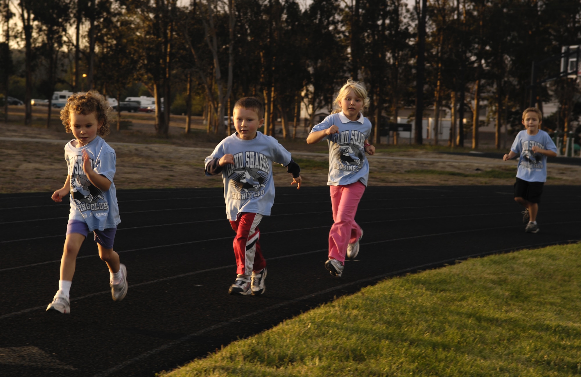 VANDENBERG AIR FORCE BASE, Calif. -- Children on the Land Sharks track team run four laps during their final meet on October 29. Proper running and stretching technique is taught to the children at every event. (U.S. Air Force photo/Airman 1st Class Christian Thomas)
