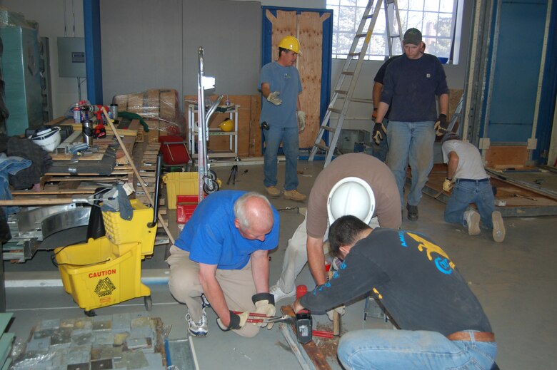 Volunteers piece together a Peacekeeper missile procedures trainer in the Pete Museum hangar Nov. 7. Peterson Airmen and members of the local community are helping the museum reassemble the mock launch control center, which will eventually become an interactive exhibit. (U.S. Air Force photo by Corey Dahl)