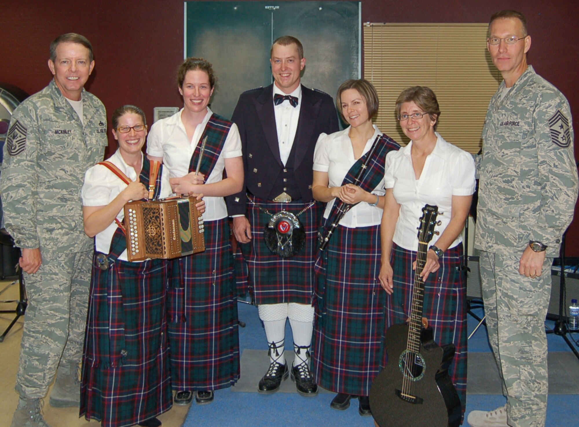 Chief Master Sergeant of the Air Force Rodney McKinley (left) and and Chief Master Sgt. Richard Small, 9th Air Force/US Central Command Air Forces command chief, pose with the USCENTAF Celtic Band "Desert Ramblers" during a break from playing for some visitors to the Combined Air and Space Operations Center in Southwest Asia.  The Desert Ramblers completed a 22-day tour visiting Coaliton Forces participating in Operation Enduring Freedom and Iraqi Freedom on Nov 7.