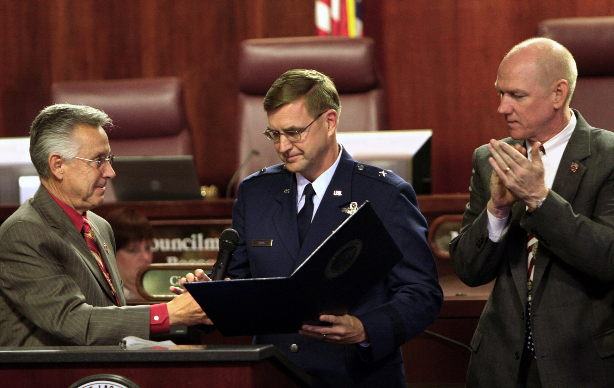 City of Las Vegas Mayor Pro Tem Gary Reese presents a proclamation to Brig. Gen. Stephen L. Hoog as Councilman Larry Brown looks on Nov. 7 in Las Vegas. The proclamation recognizes the 60th anniversary of the Air Force and proclaimed Nov. 5 through 11 as Air Force Week in Nevada. Air Force officials hosted several events to commemorate the occasion culminating in the Nellis Aviation Nation Air Show Nov. 10 and 11. General Hoog is the 57th Wing commander at Nellis Air Force Base, Nev. (U.S. Air Force photo/Lawrence Crespo)
