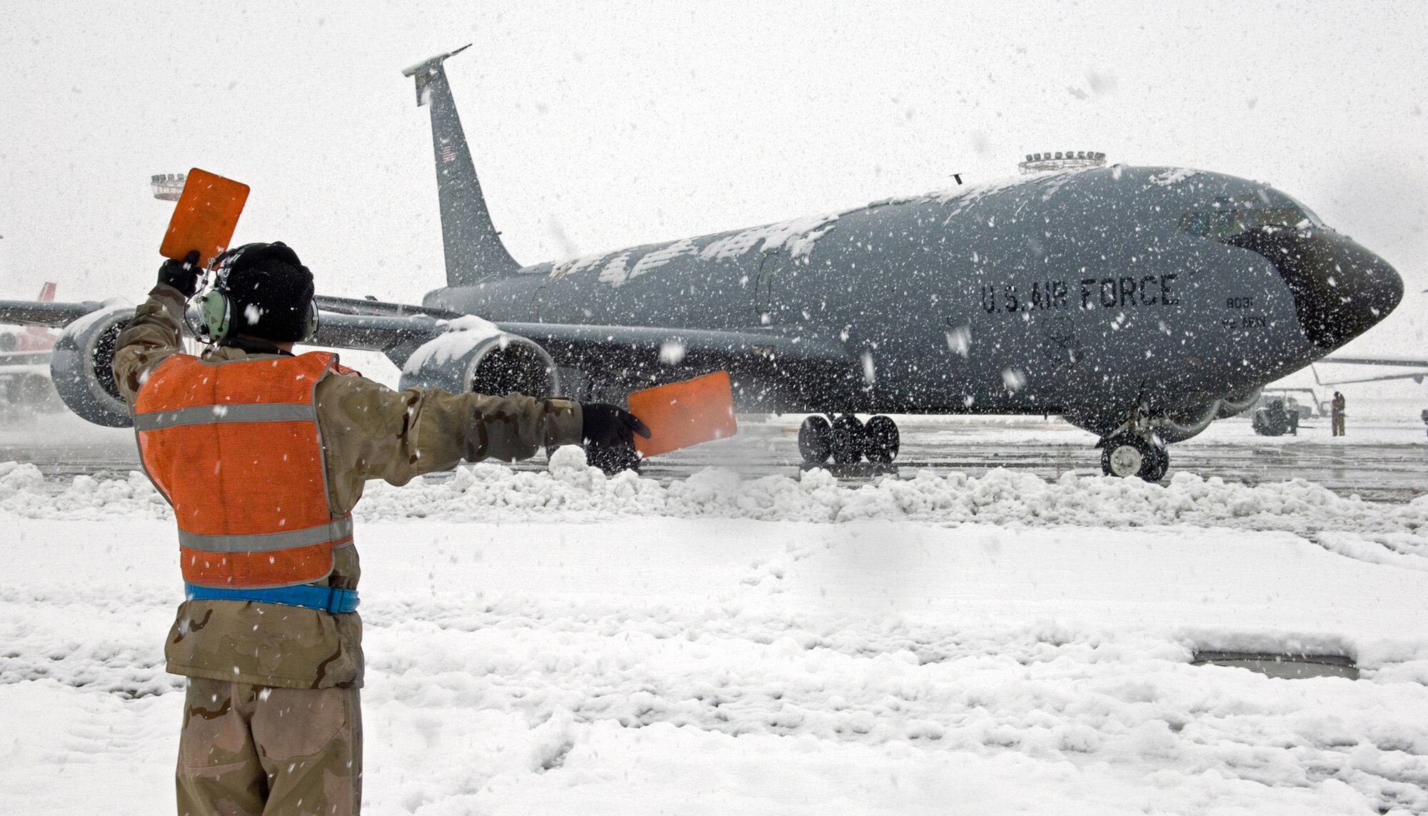 Staff Sgt. Manuel Garibay directs an Air Force KC-135 Stratotanker out for a refueling mission at Manas Air Base, Kyrgyzstan. On Nov. 11, aerial refueling crews flew 44 sorties and off-loaded approximately 2.6 million pounds of fuel to 233 receiving aircraft. Sergeant Garibay is a maintainer with the 376th Air Expeditionary Wing. (U.S. Air Force photo/James Westfall)