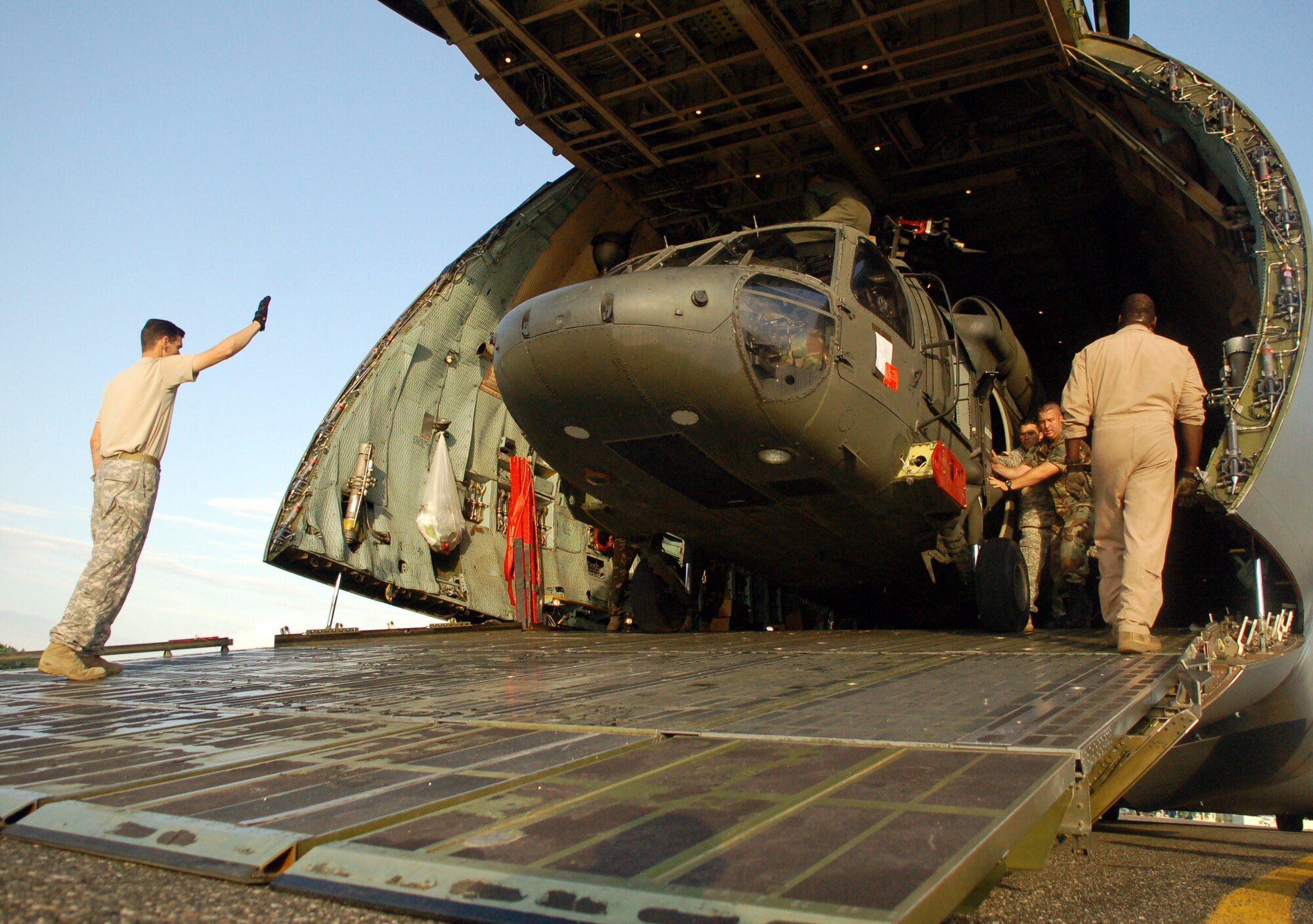 The first of two Army UH-60 Blackhawk helicopters is unloaded Nov. 8 from an C-5 Galaxy on the flightline at San Isidro Air Base, Dominican Republic, in preparation for medical relief missions following Tropical Storm Noel. Servicemembers deployed from Joint Task Force-Bravo at Soto Cano Air Base, Honduras, to assist the Dominican Republic after it was ravaged are now refocusing efforts  from search and rescue to helping the sick and injured.  (U.S. Air Force photo/Staff Sgt. Austin M. May) 
