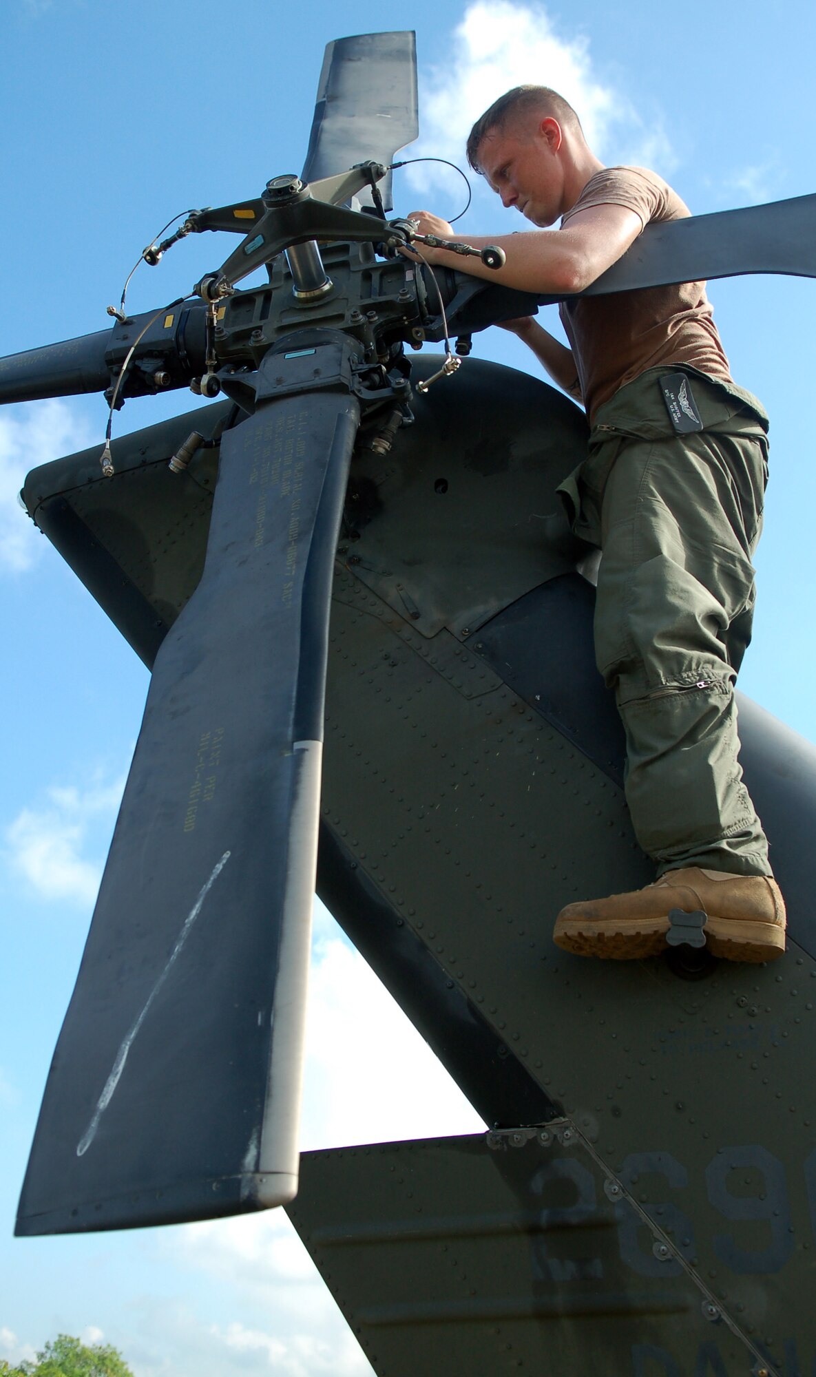 Army Spc. Ian Shaffer secures the blades of the tail rotor on an Army UH-60 Blackhawk helicopter at San Isidro Air Base, Dominicn Republic, preparing it for medical relief missions following Tropical Storm Noel. Servicemembers are deployed from Joint Task Force-Bravo at Soto Cano Air Base, Honduras. Specialist Shaffer is with the 1st Battalion, 228th Aviation Regimen. (U.S. Air Force photo/Staff Sgt. Austin M. May) 