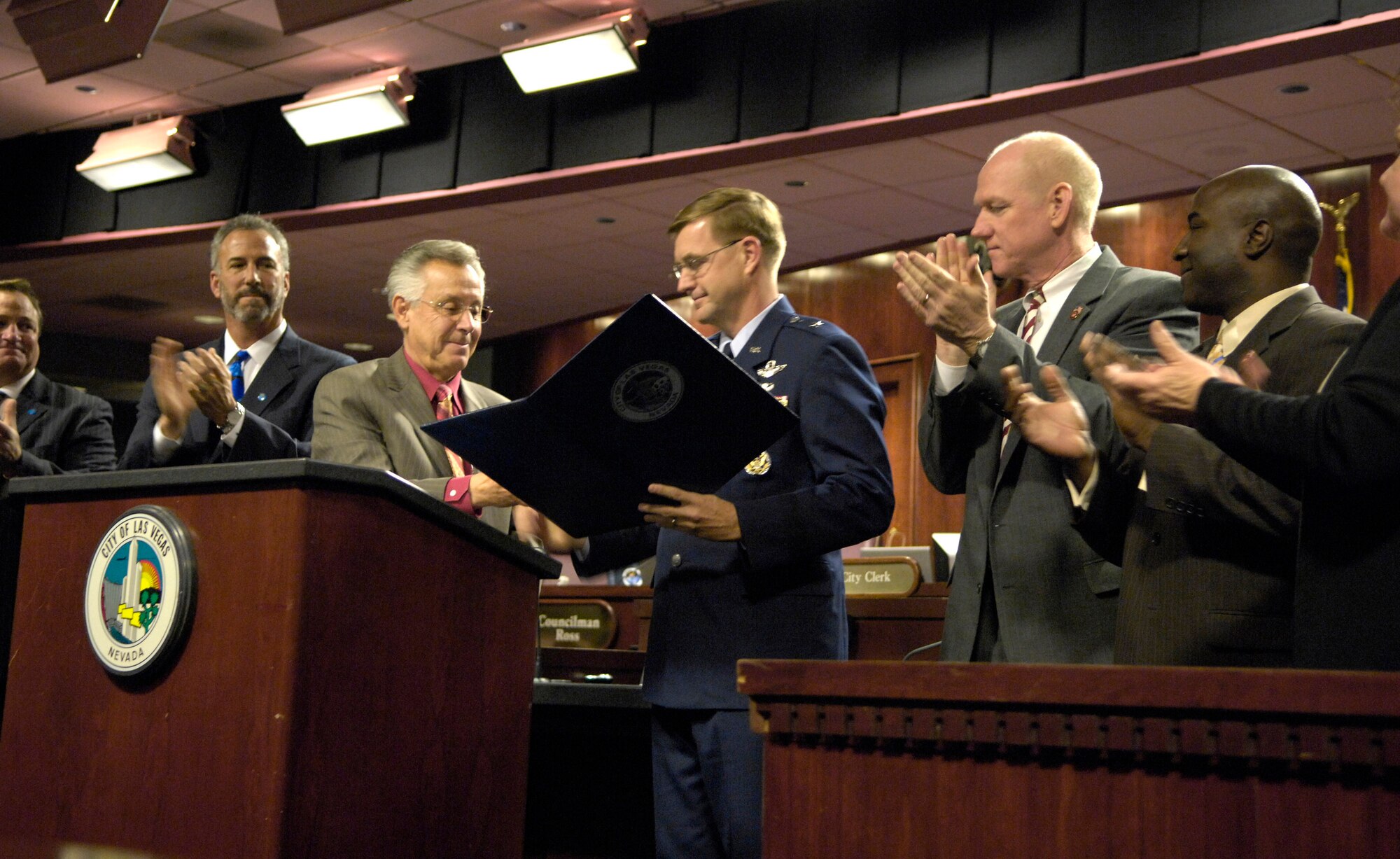 Las Vegas Councilman Gary Reese hands Brig. Gen. Stephen L. Hoog a certificate proclaiming Nov. 5 through 11 as Air Force Week Nov. 8 in Las Vegas. Air Force officials hosted several events to commemorate the occasion culminating in the Nellis Aviation Nation Air Show Nov. 10 and 11. General Hoog is the 57th Wing commander at Nellis Air Force Base, Nev. (U.S. Air Force photo by Staff Sgt. Kenny Kennemer)
