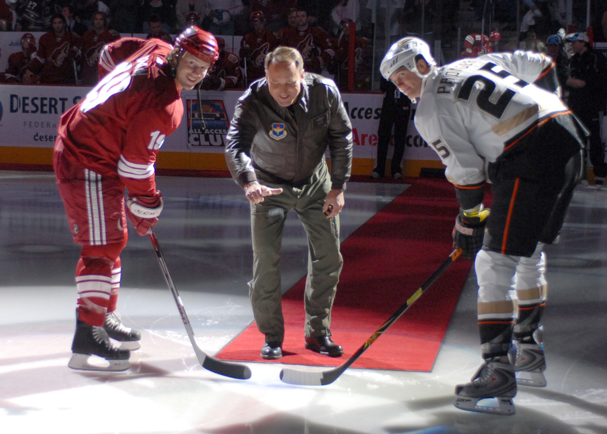 Brig. Gen. Tom Jones, 56th Fighter Wing commander, drops the puck at the Phoenix Coyotes Military Appreciation Night hockey game Nov. 3. This was one of more than a dozen events in which Luke Airmen participated as part of local Veterans' Day fesitivities. Others included an Arizona Cardinals football game, NASCAR events at Phoenix International Raceway, countless public speaking engagements and more. (photo by Staff Sgt. Ian Dean)