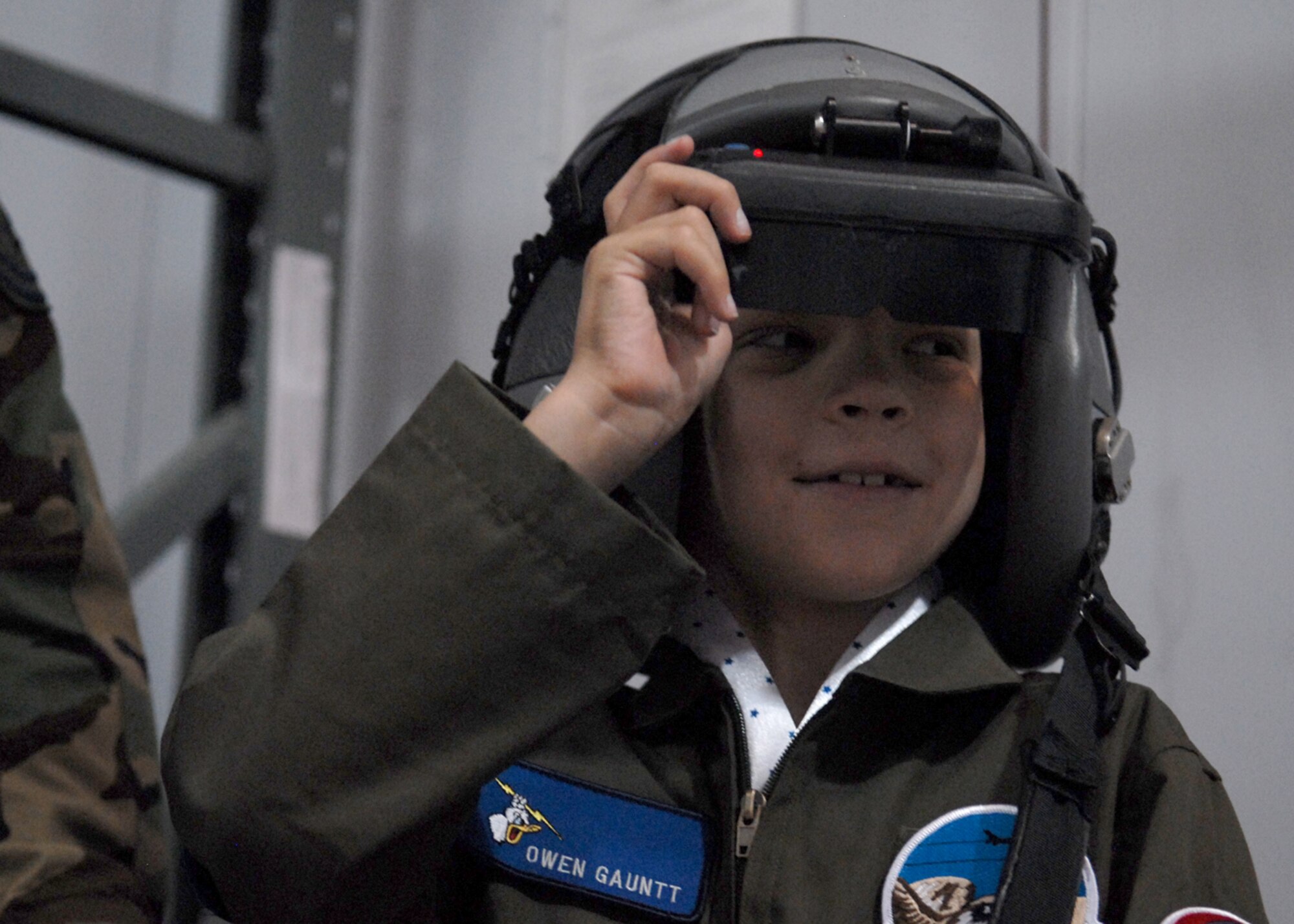 Owen Gauntt, pilot for a day, dons a pair of para-sim goggles to get the feel for what it’s like to be a real pilot at the 309th Fighter Squadron Nov. 5. (photo by Airman 1st Class Gustavo Gonzalez)