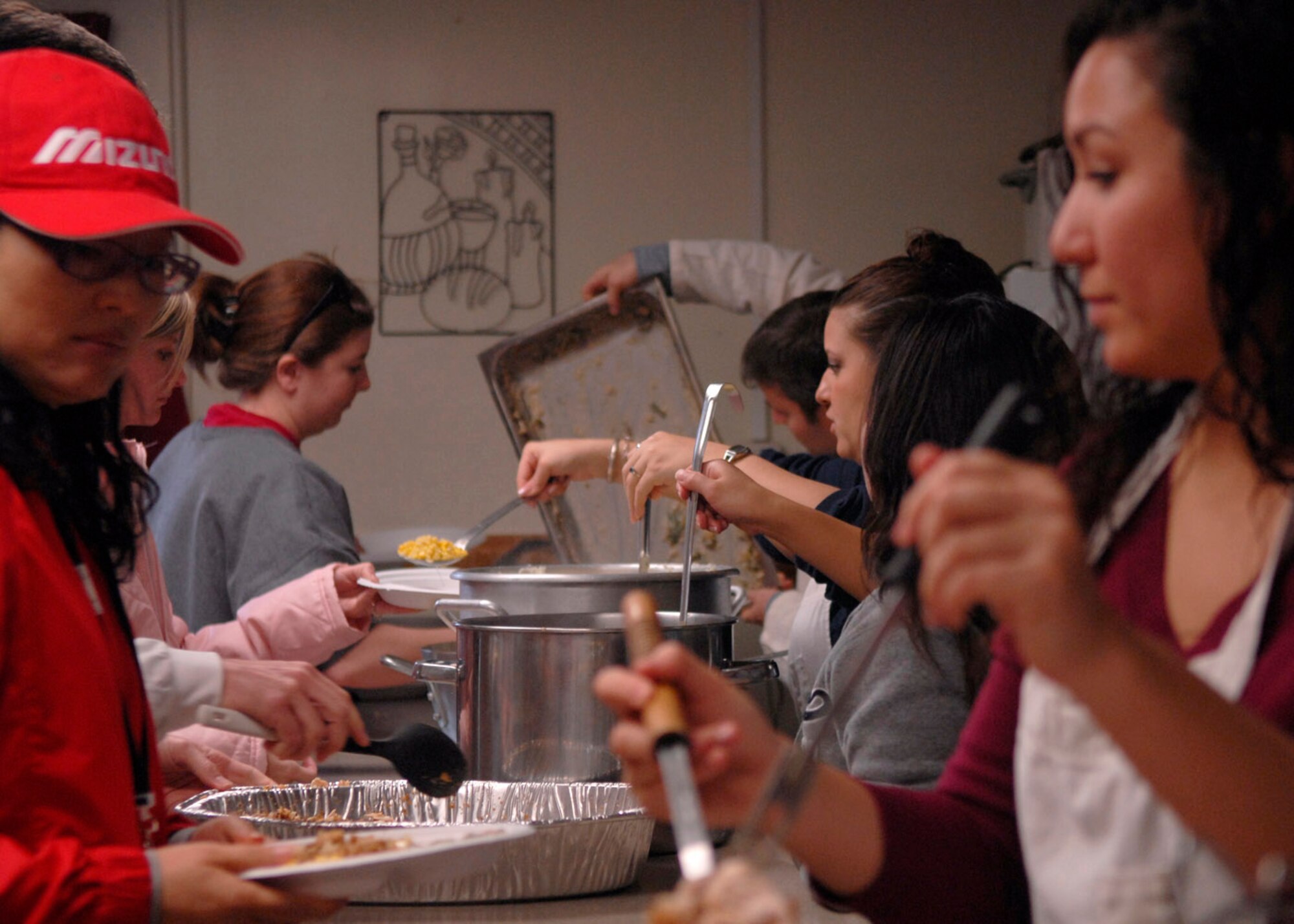 KUNSAN AIR BASE, South Korea— Airmen from the 8th Fighter Wing prepare Thanksgiving meals for local nationals at the Sonlight Inn here Nov 10 . The Good Neighbor Program is designed for the base to actively engage with the local community to strengthen ties (U.S. Air Force photo/Staff Sgt. Araceli Alarcon)

