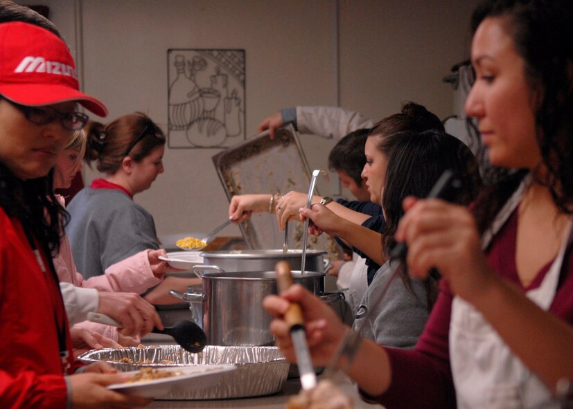 KUNSAN AIR BASE, South Korea— Airmen from the 8th Fighter Wing prepare Thanksgiving meals for local nationals at the Sonlight Inn here Nov 10 . The Good Neighbor Program is designed for the base to actively engage with the local community to strengthen ties (U.S. Air Force photo/Staff Sgt. Araceli Alarcon)

