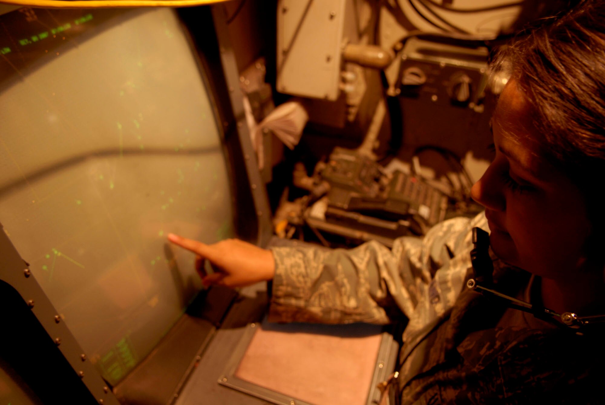 BALAD AIR BASE, Iraq -- Senior Airman Kelli Anguiano, a 727th Expeditionary Air Control Squadron surveillance technician, monitors a display to identify civilian and military aircraft flying in Iraqi airspace. By knowing where each aircraft is, Airman Anguiano is able to help the weapon directors who deconflict the flight altitude of aircraft in their area of responsibility. Also known as Kingpin, the 727th EACS is responsible for maintaining positive control over aircraft operating in Iraq's 277,000 miles of airspace. (U.S. Air Force photo/Staff Sgt. Joshua Garcia)