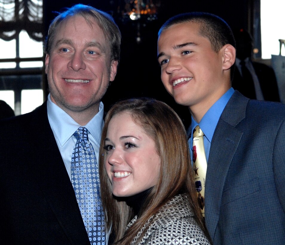 Boston Red Sox pitcher Curt Schilling poses for a picture with Brittany and Robbie Bergquist following the Microsoft Above and Beyond Awards Ceremony Nov. 12, 2007, in New York. The Bergquists set up a program to send prepaid calling cards to servicemembers in Iraq, started in 2004 when they were 13 and 12 years old, respectively. 