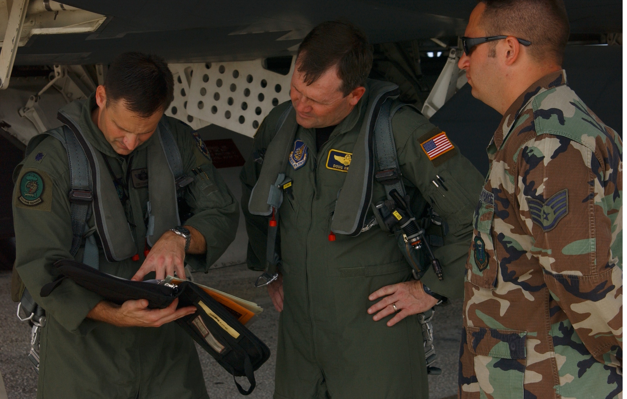 Lt. Col. Todd Copeland, 393rd Expeditionary Bomb Squadron director of operations (left) and Brig. Gen. Douglas Owens look over this stealth’s maintenance forms as B-2 crew chief Staff Sgt. Scott West stands by to answer any technical questions about this particular aircraft’s maintenance cycles. The U.S. Air Force is unique in that it trusts the highest caliber of enlisted personnel with America’s deadliest bomber. Studies show other nations only trust work such as what Sergeant West does every day to their officer corps. (Air Force photo/Tech. Sgt. Steven Wilson)