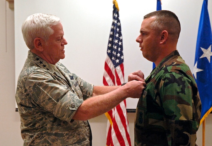 General Lichte takes the time during his visit of Charleston AFB to honor Capt. Dana Metzger, 437th Security Forces Squadron operations officer, by pinning on his Bronze Star Nov. 10. (U.S. Air Force photo/Staff Sgt. April Quintanilla)