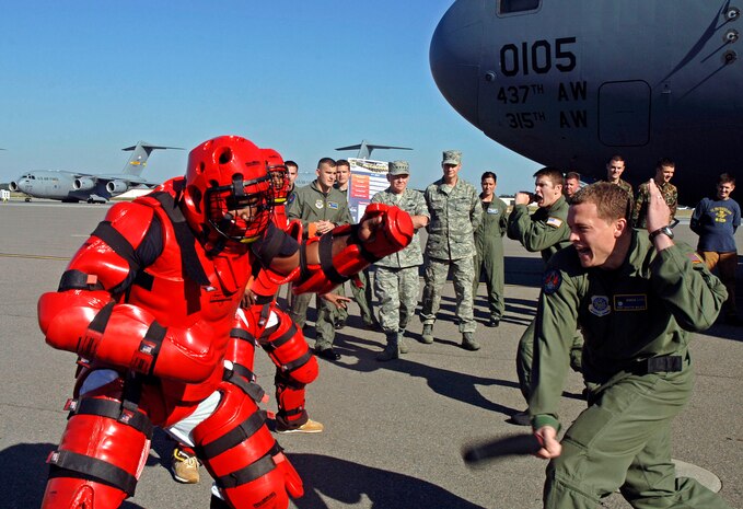 General Lichte watches as Staff Sgt. Scottie Wilder and Senior Airman Jeremy Lloyd, 437th Security Forces Squadron Ravens, demonstrate how they handle aggressors portrayed by Staff Sgt. Brien Oxford and Tech. Sgt. James White, 437 SFS, as they try to take over the plane.  (U.S. Air Force photo/Staff Sgt. April Quintanilla)