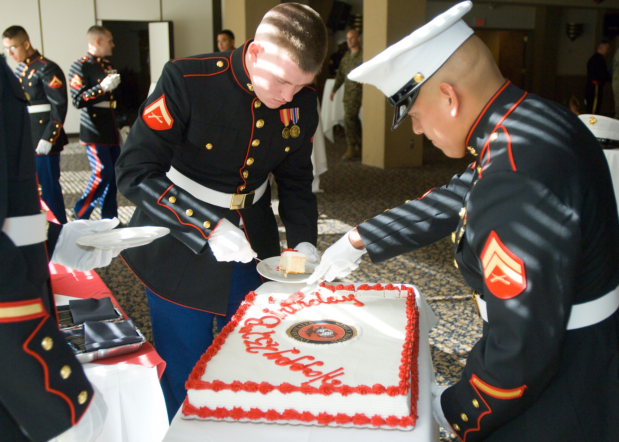 Lance Cpl. Lawrence Latinette II (left) and Cpl. Cecilio Garcia (right), Marine Aircraft Group 46 Detachment B, cut the cake during the 232nd Marine Corps Birthday Cake Cutting Ceremony at Club Muroc here Nov. 7. (Photo by Mike Cassidy)