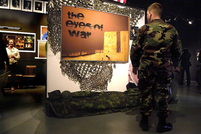 Staff Sgt. Richard Rose, 1st Combat Camera Squadron, looks at one of the photographs taken by Staff Sgt. Stacy Pearsall at the Alterman Studio Center for Photography in downtown Charleston. The photographs of Tech. Sgt. Jeremy Lock, Staff Sgt. Jacob Bailey and Sergeant Pearsall will be on display until Dec. 31. (U.S. Air Force photo/Senior Airman Nicholas Pilch)