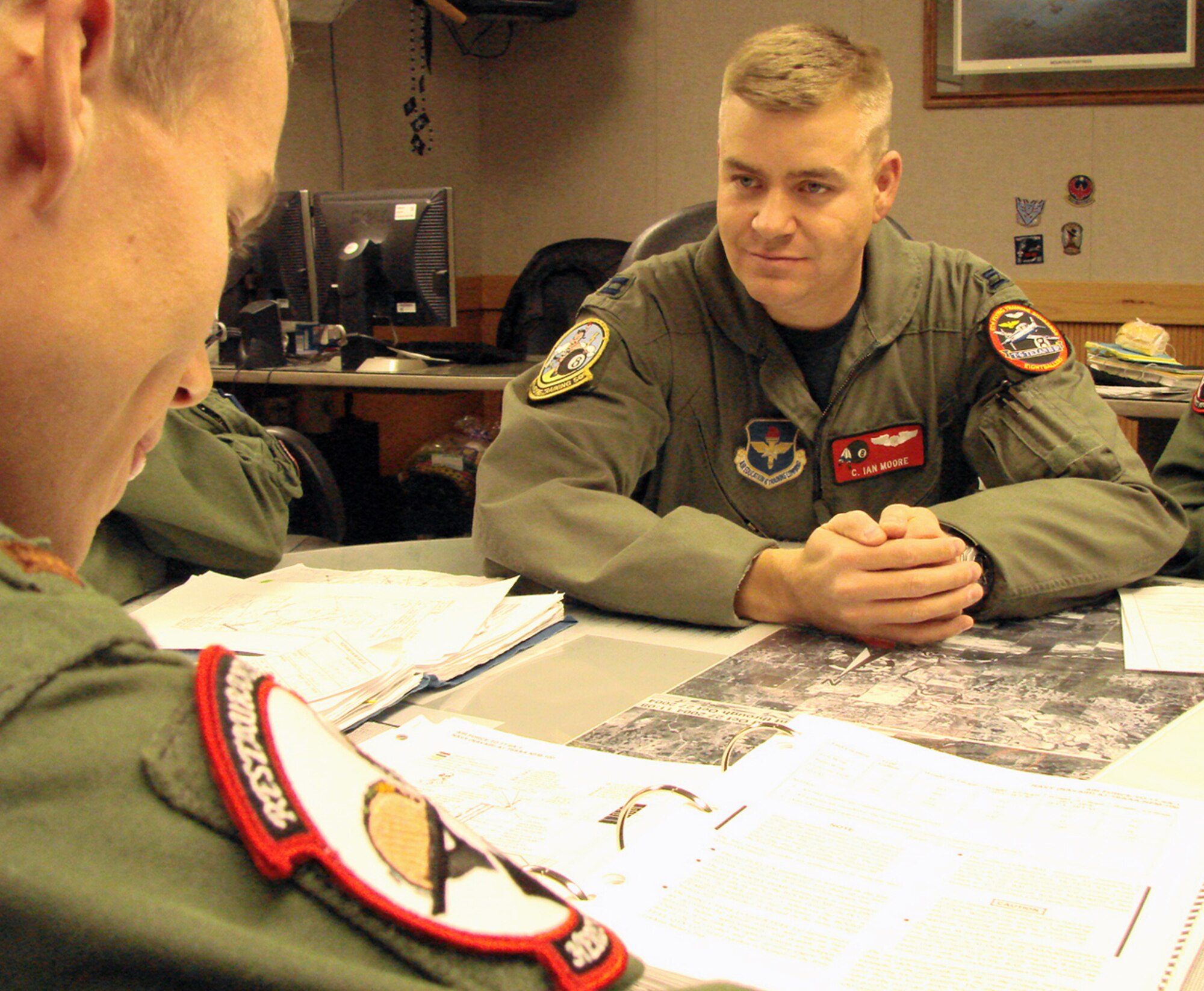 Capt. C. Ian Moore, assistant Director of Operations and instructor pilot with the 8th Flying Training Squadron, explains a lesson to a student. Captain Moore was recently named the 71st Flying Training Wing Warrior of the Month. (U.S. Air Force photo by Tech. Sgt. Mary Davis)