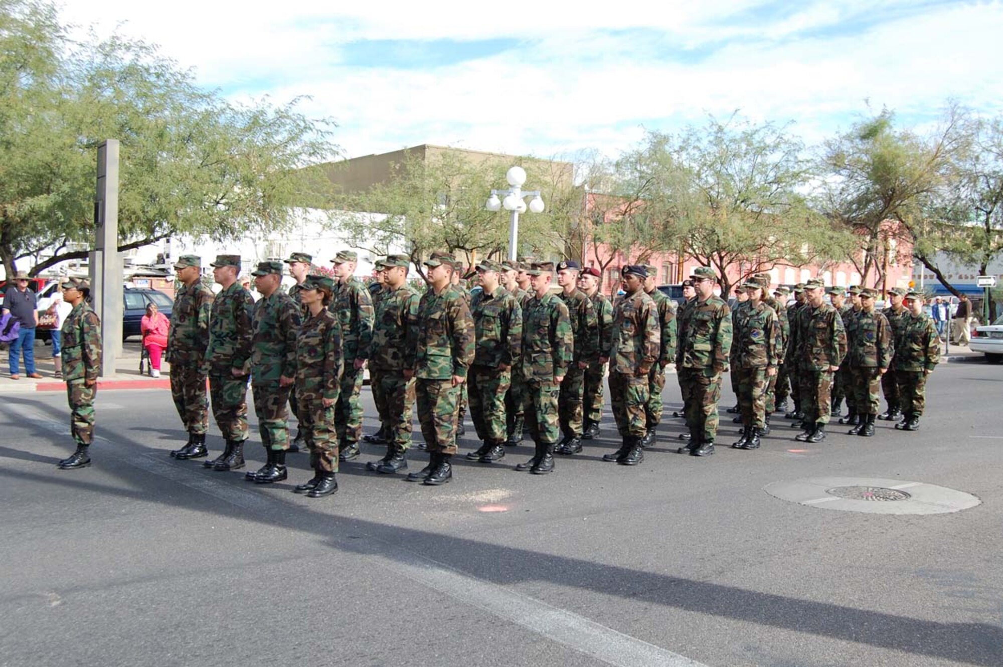 Members from Davis-Monthan's Airman Leadership School prepare to march during the Veteran's Day Parade in downtown Tucson Nov. 12. The parade, hosted by the American Legion Post Seven and the city of Tucson, drew hundreds of spectators to downtown Tucson to watch veterans' organizations, color guards, military formations, high school marching bands, and a four-ship F-16 flyover by the 162nd Fighter Wing. (U.S. Air Force photo by 2nd Lt. Mary Pekas)