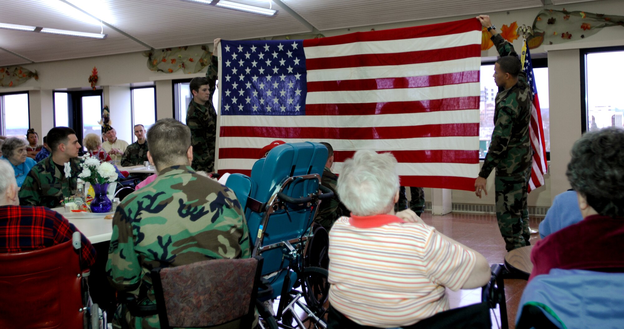 ANCHORAGE, Alaska -- U.S. Air Force members from Elmendorf Air Force Base come together to show their appreciation during the Veterans Appreciation Celebration at the Pioneer Retirement Home here Nov. 9. Air Force members entertained the veterans with a story, a flag folding dedication, and ice cream and cake. (U.S. Air Force photo by Airman 1st Class Tinese Treadwell)