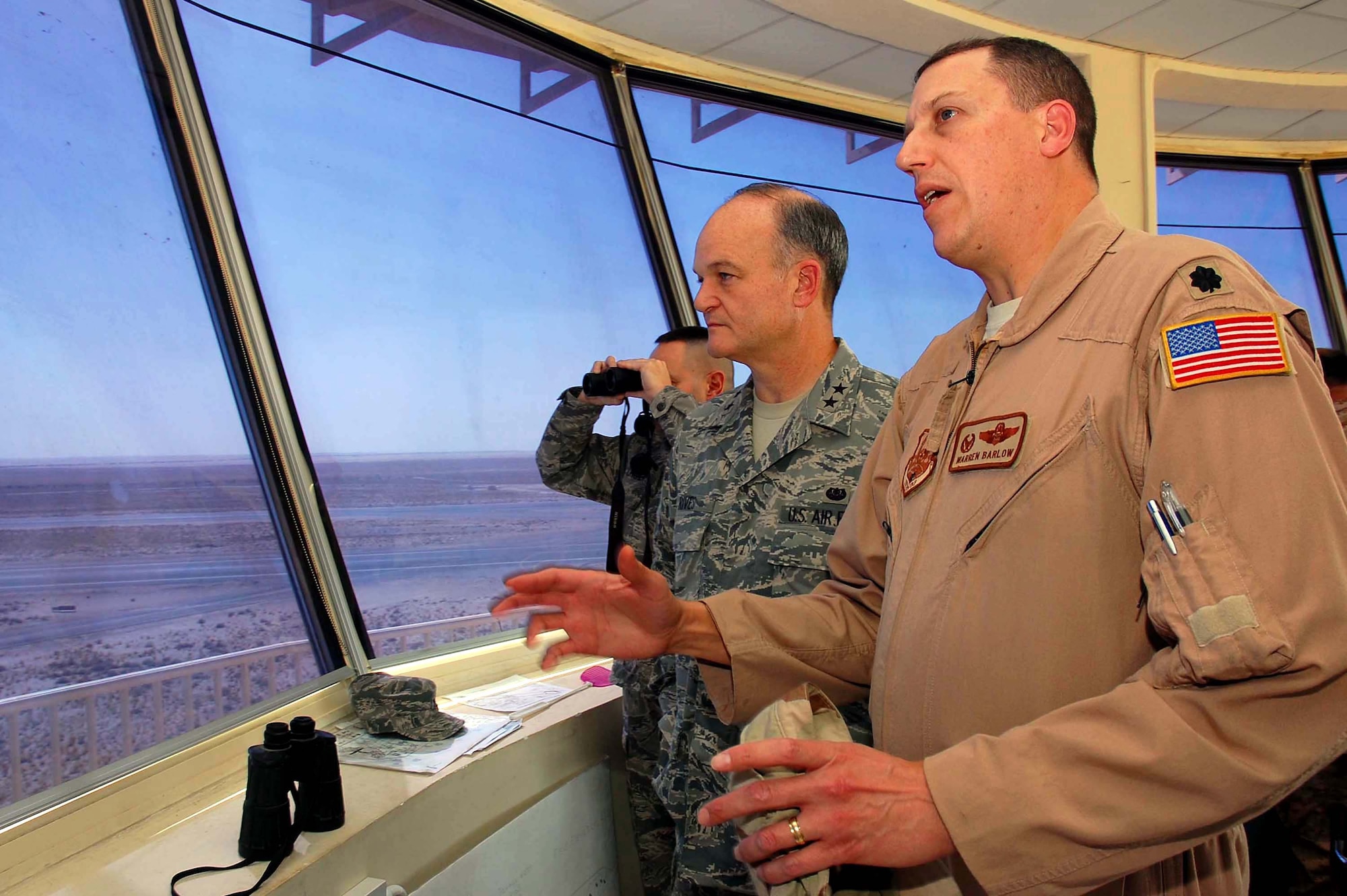 Maj. Gen. Jack L. Rives discusses airfield operations with Lt. Col. Warren Barlow at an undisclosed location Nov. 8 in Southwest Asia. General Rives' visit included reviewing the 386th Air Expeditionary Wing's legal programs and meeting with deployed Airmen from units around the world. Geeral Rives is the Air Force judge advocate general and Colonel Barlow is the 386th Air Expeditionary Operations Support Squadron commander. (U.S. Air Force photo by Staff Sgt. Tia Schroeder)