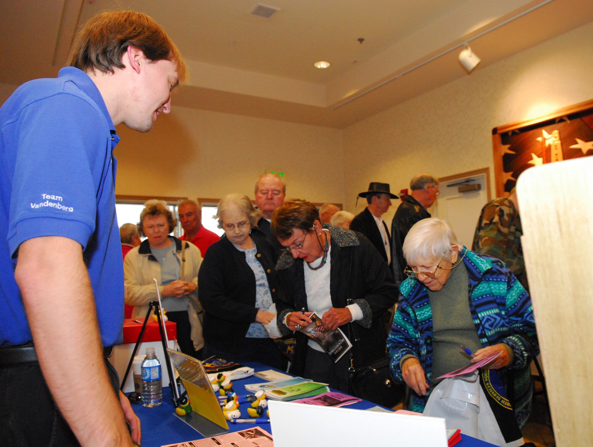 VANDENBERG AIR FORCE BASE, Calif. -- Michael Peterson assists retired military in signing up for a $2,000 cruise package drawing during the opening of the annual Retired Member Appreciation Day in the Pacific Coast Club on Nov. 9. The 30th Services Division illustrator helped run the event which recognized contributions of retired military members, including those who served on active, guard and reserve duty. (U.S. Air Force Photo/Airman 1st Class Ashley Tyler)