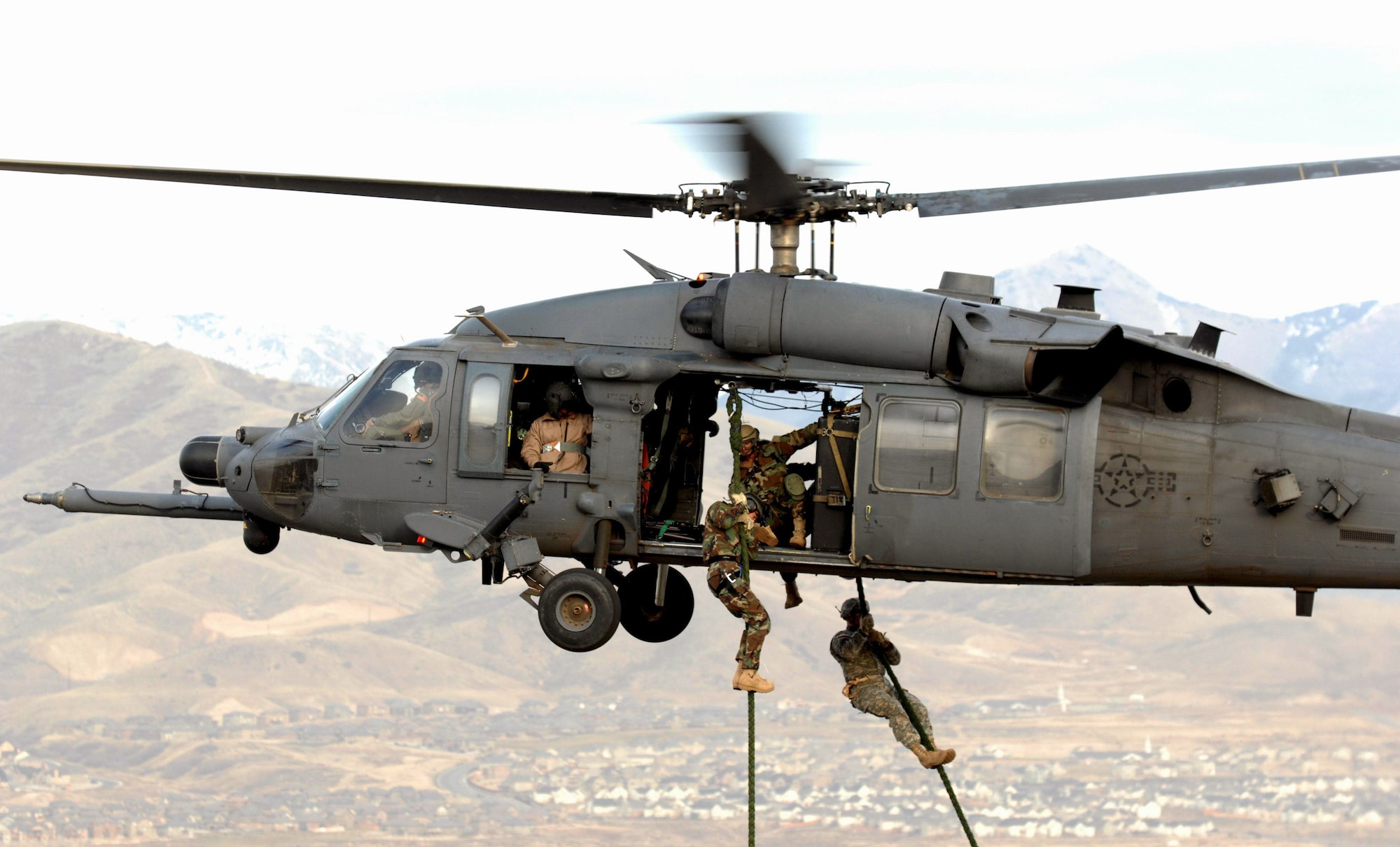 A Utah National Guard Soldier and 19th Special Forces member are lifted on board an HH-60 Pave Hawk during a combat search and rescue integration exercise Nov. 9 over the Utah Test and Training Range. Members of the 34th Weapons Squadron from Nellis AFB led the search and recovery training. The exercise expanded the integration with Utah's 211th Aviation Group AH-64 Apache Joint Rotary Wing, 4th Fighter Squadron F-16 Fighting Falcon assets from Hill AFB, Utah, and special operations forces. Exercise participants also conducted extensive joint combat search and rescue operations against surface-to-air threats. The exercise is being run held Nov. 6 through 15. (U.S. Air Force photo/Master Sgt. Kevin J. Gruenwald) 
