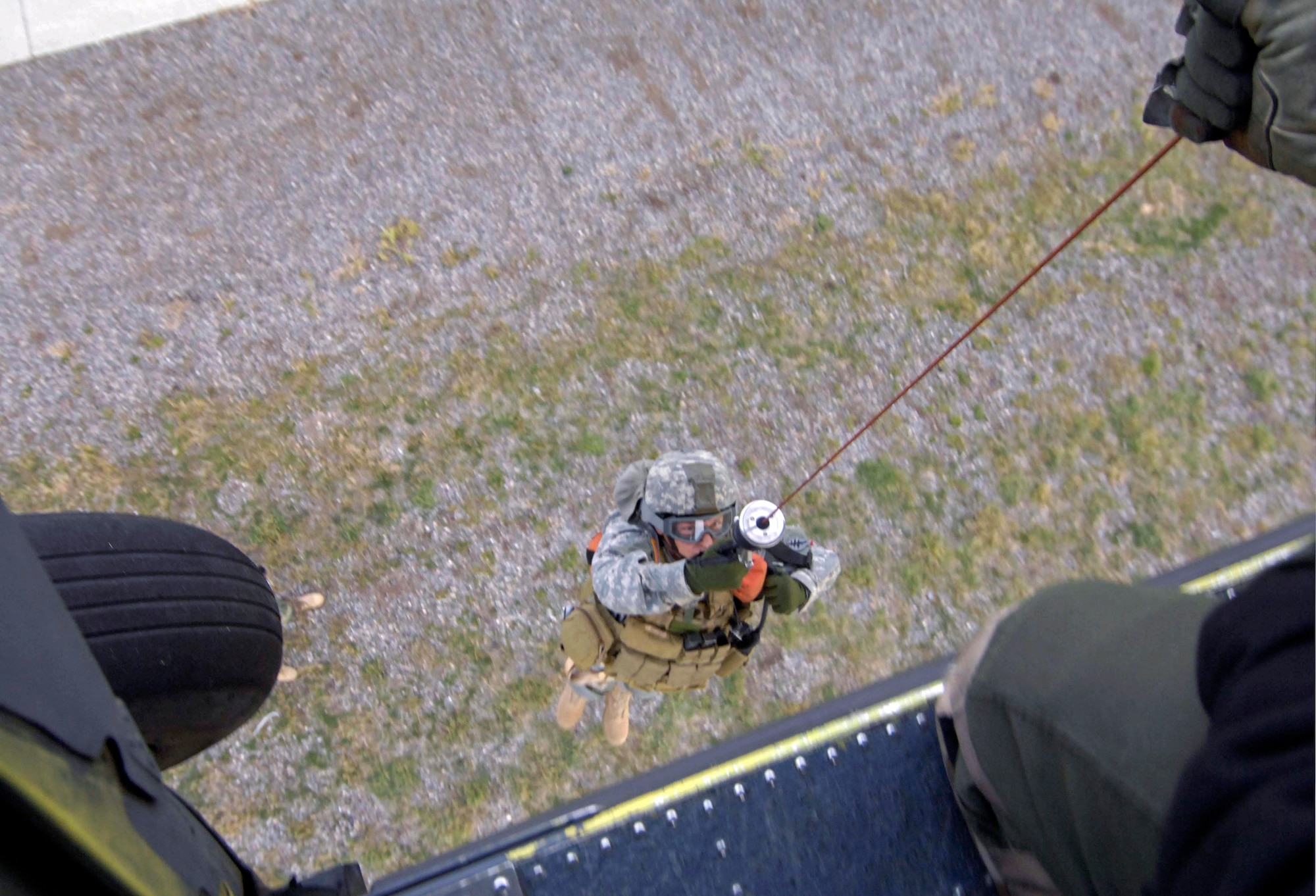 A Utah National Guard Soldier is hoisted on board an HH-60 Pave Hawk during a combat search and rescue integration exercise Nov. 9 at Camp Williams, Utah.  Members of the 34th Weapons Squadron from Nellis AFB led the search and recovery training. The exercise expanded the integration with Utah's 211th Aviation Group AH-64 Apache Joint Rotary Wing, 4th Fighter Squadron F-16 Fighting Falcon assets from Hill AFB, Utah, and special operations forces. Exercise participants also conducted extensive joint combat search and rescue operations against surface-to-air threats. The exercise is being run held Nov. 6 through 15. (U.S. Air Force photo/Master Sgt. Kevin J. Gruenwald) 
