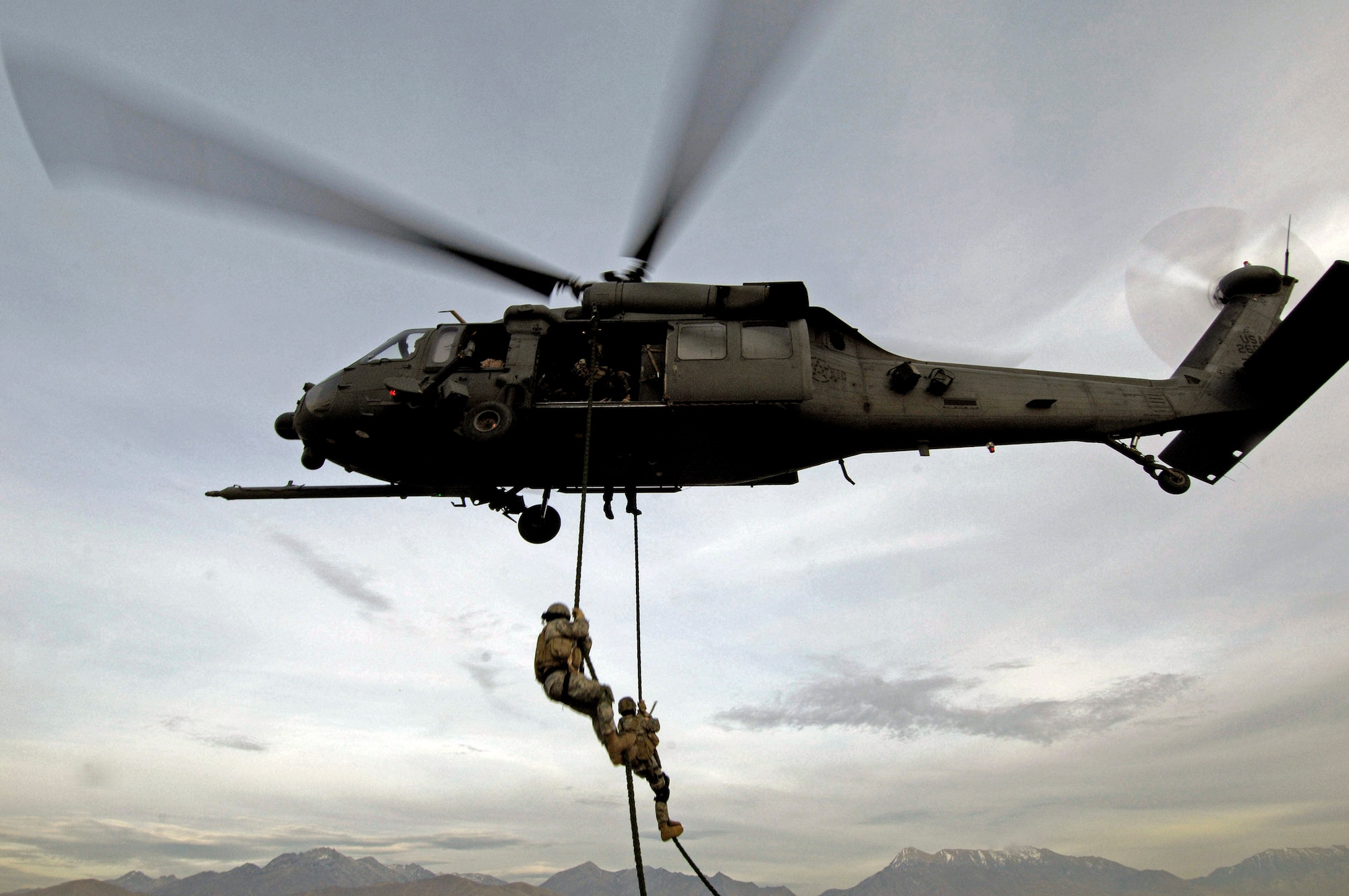 A Utah National Guard Soldier and 19th Special Forces member are lifted on board an HH-60 Pave Hawk over the Utah Test and Training Range during a combat search and rescue integration exercise Nov. 9. Members of the 34th Weapons Squadron from Nellis AFB led the search and recovery training. The exercise expanded the integration with Utah's 211th Aviation Group AH-64 Apache Joint Rotary Wing, 4th Fighter Squadron F-16 Fighting Falcon assets from Hill AFB, Utah, and special operations forces. Exercise participants also conducted extensive joint combat search and rescue operations against surface-to-air threats. The exercise is being run held Nov. 6 through 15. (U.S. Air Force photo/Master Sgt. Kevin J. Gruenwald) 
