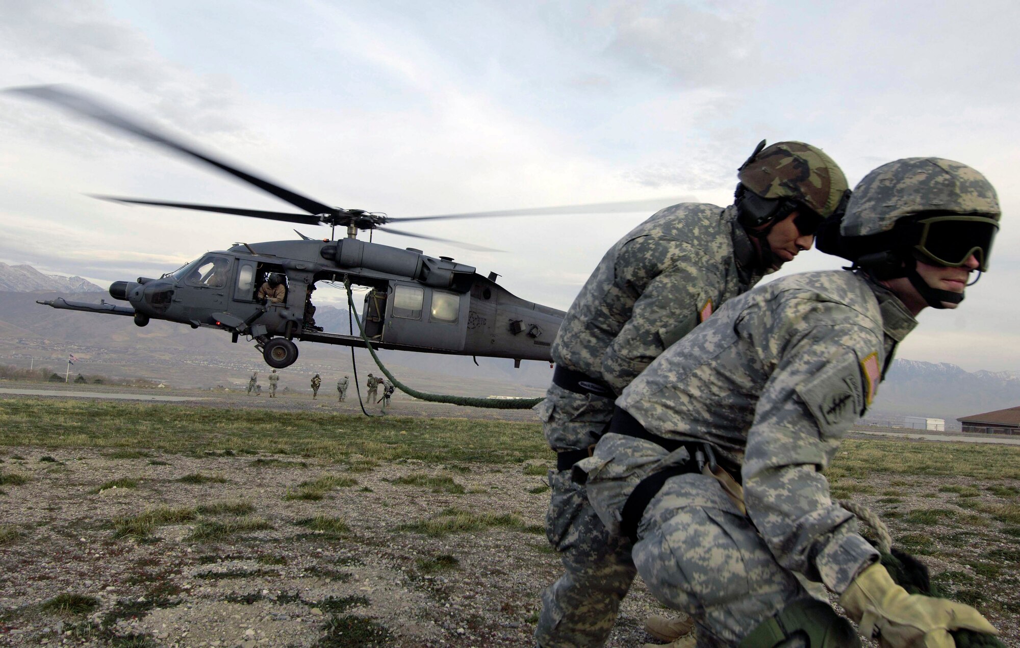 Utah National Guard Soldiers and 19th Special Forces members retrieve a fast rope after being dropped into a landing zone by an HH-60 Pave Hawk during a combat search and rescue integration exercise Nov. 8 at Camp Williams, Utah. Members of the 34th Weapons Squadron from Nellis AFB led the search and recovery training. The exercise expanded the integration with Utah's 211th Aviation Group AH-64 Apache Joint Rotary Wing, 4th Fighter Squadron F-16 Fighting Falcon assets from Hill AFB, Utah, and special operations forces. Exercise participants also conducted extensive joint combat search and rescue operations against surface-to-air threats. The exercise is being run held Nov. 6 through 15. (U.S. Air Force photo/Master Sgt. Kevin J. Gruenwald) 
