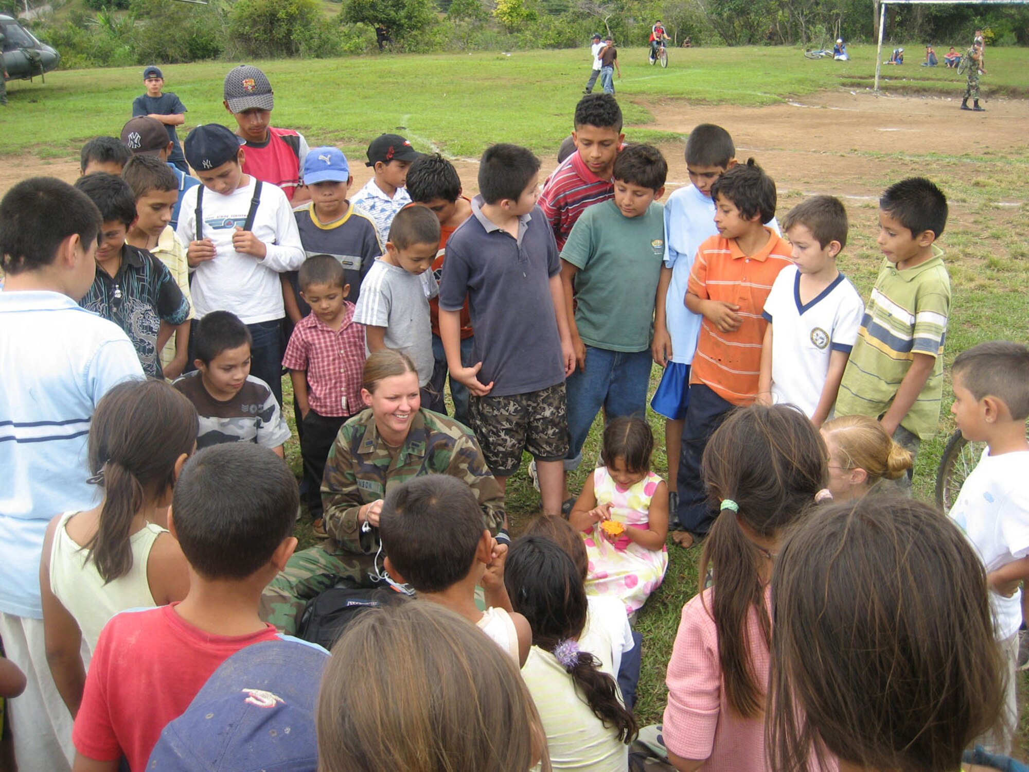 CORINTO, El Salvador -- Air Force 1st Lt. Vanessa Johnson, chief of medical logistics at the Medical Element from Joint Task Force-Bravo, talks with local children here Nov. 6 following a a medical readiness training exercise.  MEDEL provided medical care for 2,690 El Salvadorans. (Courtesy photo)
