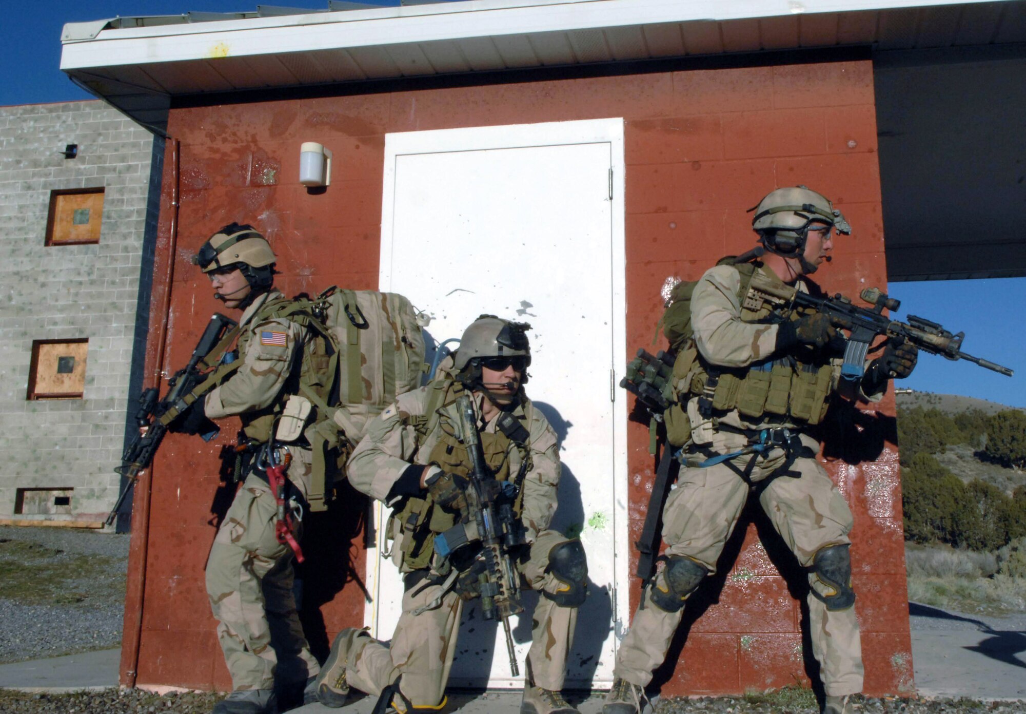 Pararescuemen make an urban village assault during an extraction of a simulated downed pilot during a combat search and rescue integration exercise Nov. 8 at Camp Williams, Utah. The pararescuemen are from the 58th Rescue Squadron, Nellis Air Force Base, Nev. Members of the 34th Weapons Squadron from Nellis AFB led the search and recovery training. The exercise expanded the integration with Utah's 211th Aviation Group AH-64 Apache Joint Rotary Wing, 4th Fighter Squadron F-16 Fighting Falcon assets from Hill AFB, Utah, and special operations forces. Exercise participants also conducted extensive joint combat search and rescue operations against surface-to-air threats. The exercise is being run held Nov. 6 through 15. (U.S. Air Force photo/Master Sgt. Kevin J. Gruenwald) 
