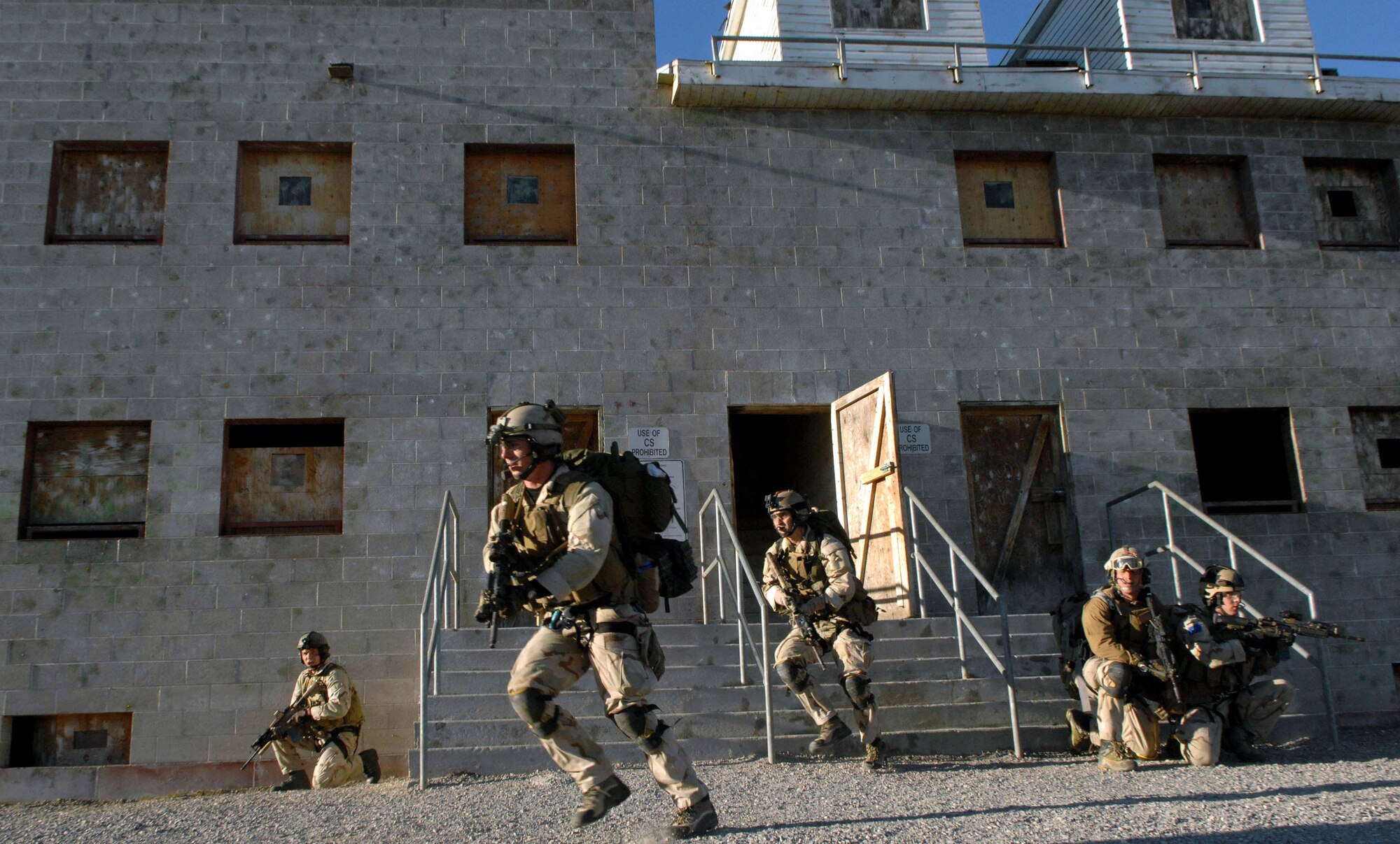 Pararescuemen make an urban village assault during an extraction of a simulated downed pilot during a combat search and rescue integration exercise Nov. 8 at Camp Williams, Utah. The pararescuemen are from the 58th Rescue Squadron, Nellis Air Force Base, Nev. Members of the 34th Weapons Squadron from Nellis AFB led the search and recovery training. The exercise expanded the integration with Utah's 211th Aviation Group AH-64 Apache Joint Rotary Wing, 4th Fighter Squadron F-16 Fighting Falcon assets from Hill AFB, Utah, and special operations forces. Exercise participants also conducted extensive joint combat search and rescue operations against surface-to-air threats. The exercise is being run held Nov. 6 through 15. (U.S. Air Force photo/Master Sgt. Kevin J. Gruenwald) 
