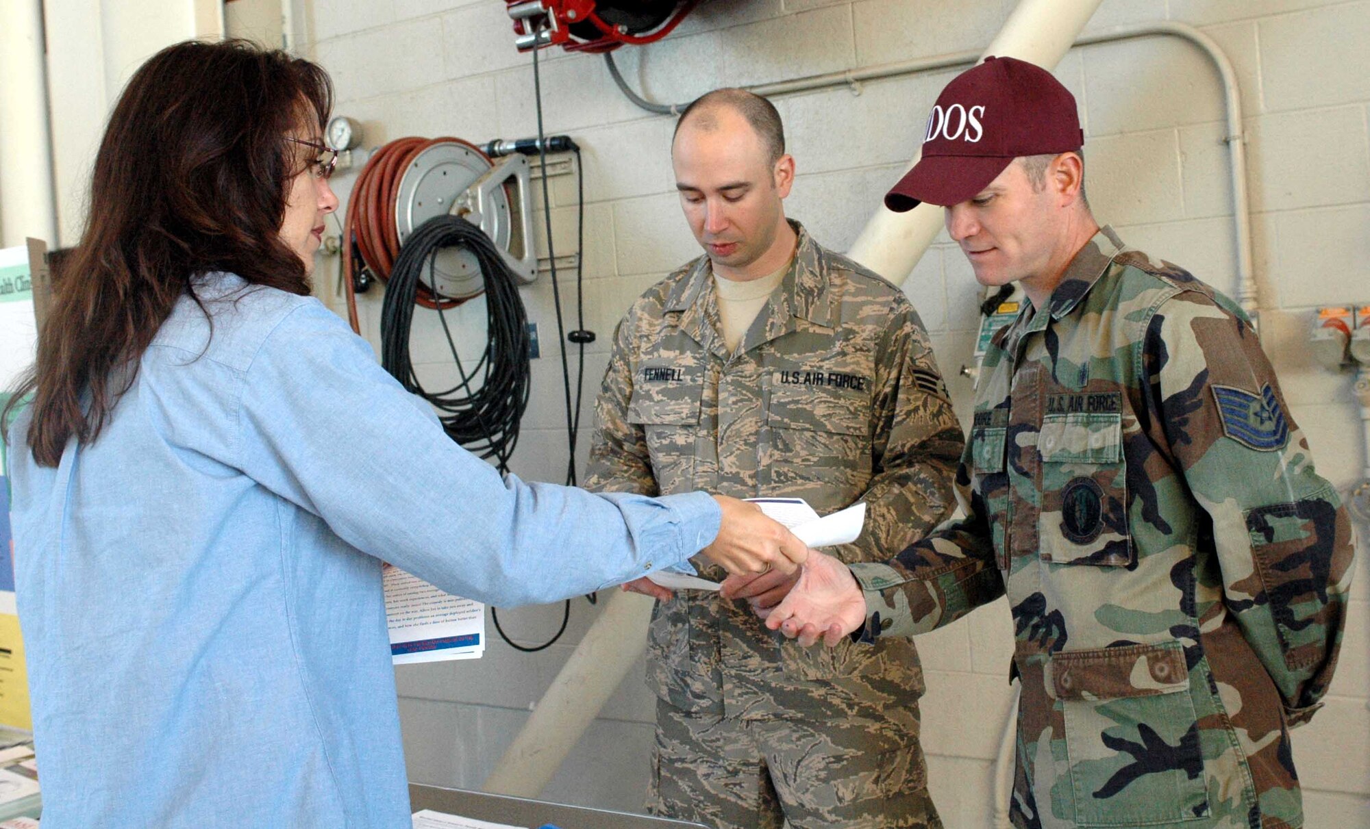 Laura Juneau, Airman and Family Readiness Center, hands out information to Airmen during Wingman Day Nov. 9. Col. GI Tuck, 60th Air Mobility Wing vice commander, briefed Team Travis members about the importance of taking care of and getting to know your fellow wingman. (U.S. Air Force photo/Staff Sgt. Candy Knight)