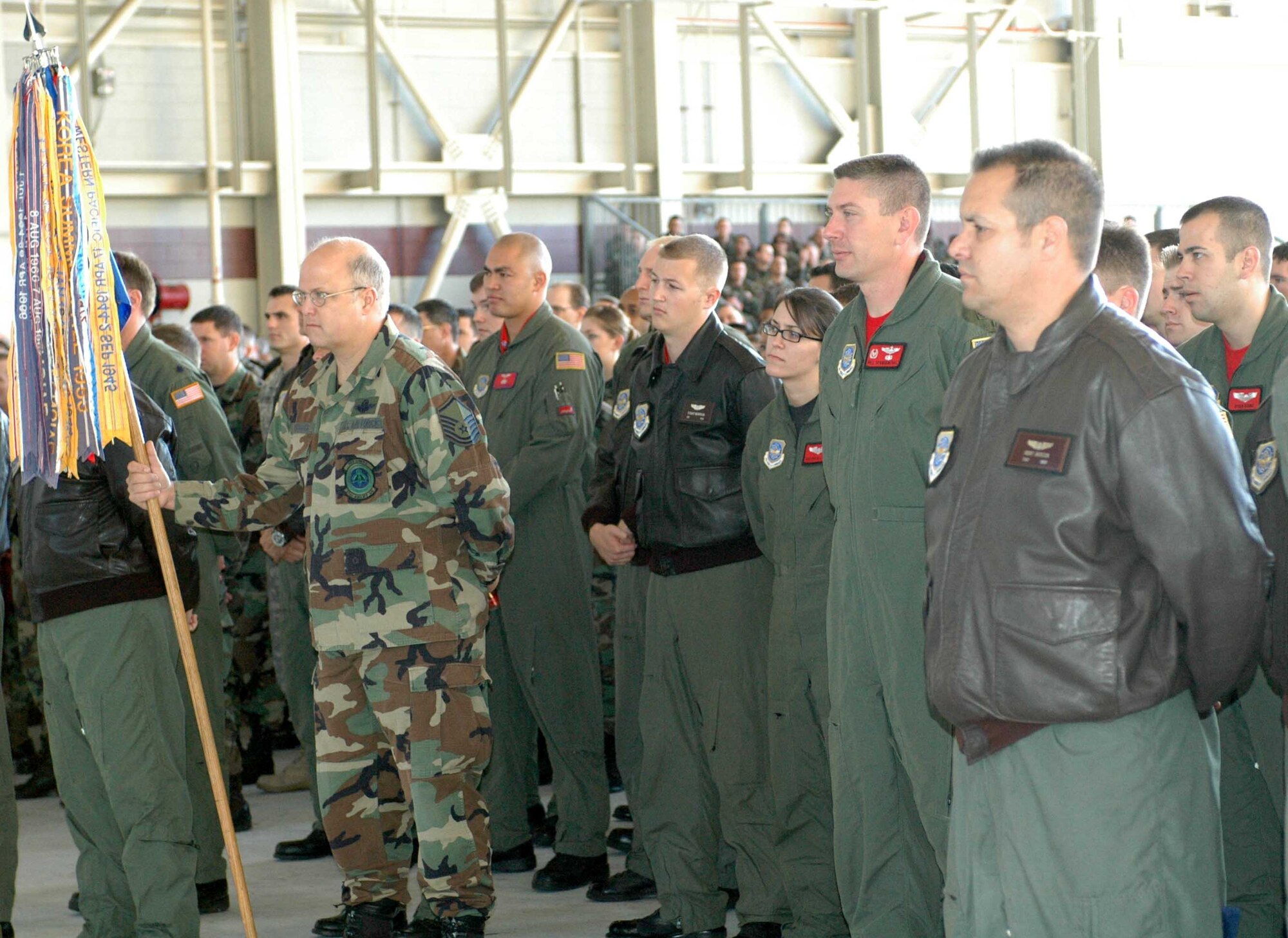 Airmen from the 21st Airlift Squadron stand in formation during a briefing for Wingman Day Nov. 9 in Hangar 14. The event was a chance for Airmen to get to know their fellow wingman and served as a reminder to practice being a good wingman every day. (U.S. Air Force photo/Staff Sgt. Candy Knight)