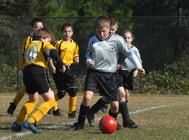 Jeremy Dubriske, 9, son of Lt. Col. Steven Dubriske, tries to get the ball past defender Jason Brule, of the Hanahan Kickers Saturday on soccer fields at Charleston AFB during the 9-10-year-old playoff games (U.S. Air Force photo/Tech. Sgt. Paul Kilgallon)