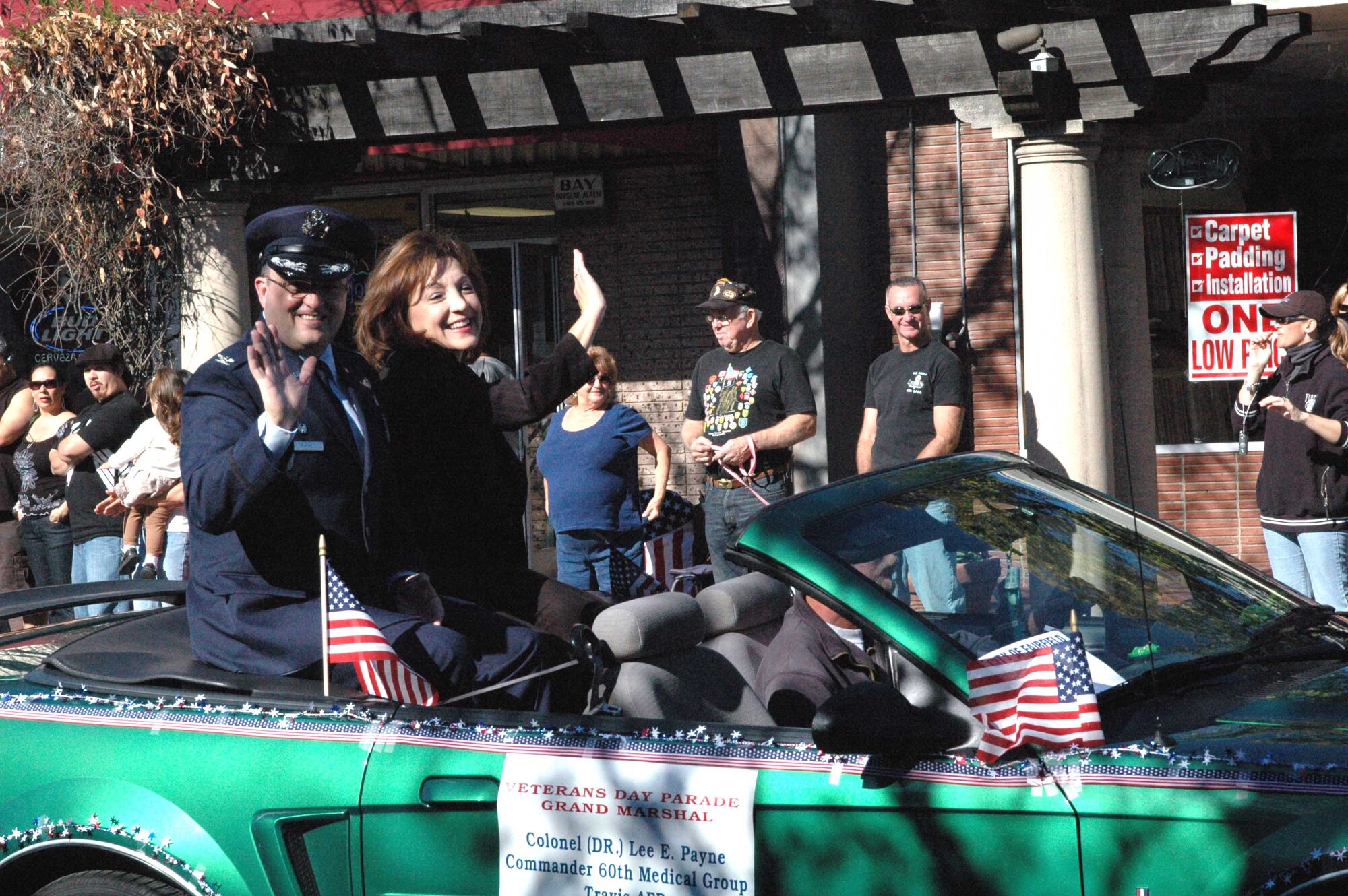 Col. Lee Payne, 60th Medical Group commander, and his wife, Bernice,wave to the crowd during the 7th Annual City of Fairfield Veterans Day Parade Nov. 11. Colonel Payne was invited to serve as one of four grand marshals for the parade. (U.S. Air Force photo by Senior Airman Shaun Emery)