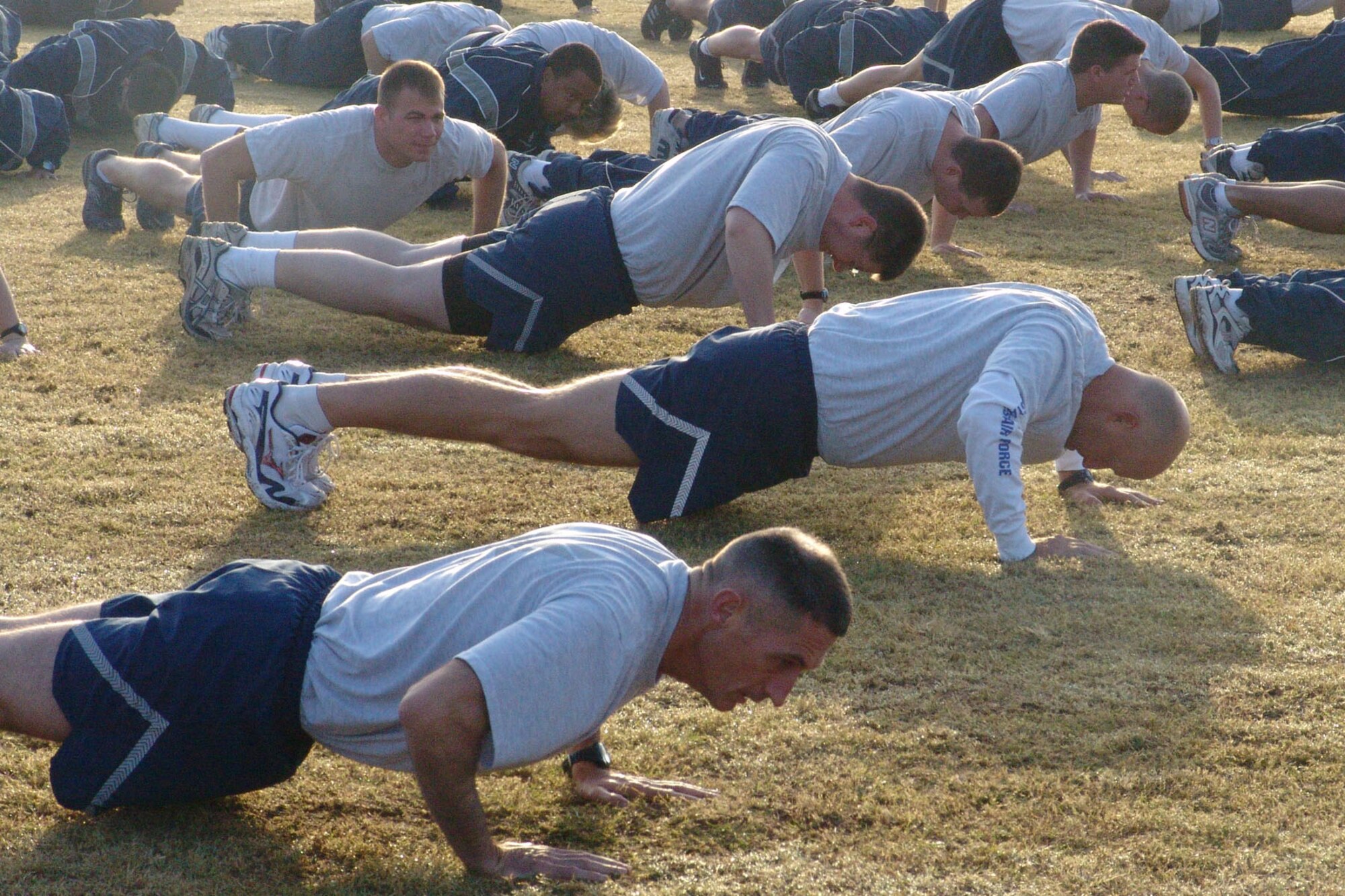 EGLIN AIR FORCE BASE, Fla. -- Air Force Materiel Command command chief Jonathan Hake does push-ups with the 96th Communications Group at their morning physical fitness training. The chief spent the day visiting troops around the base. (USAF photo by Lois Walsh)