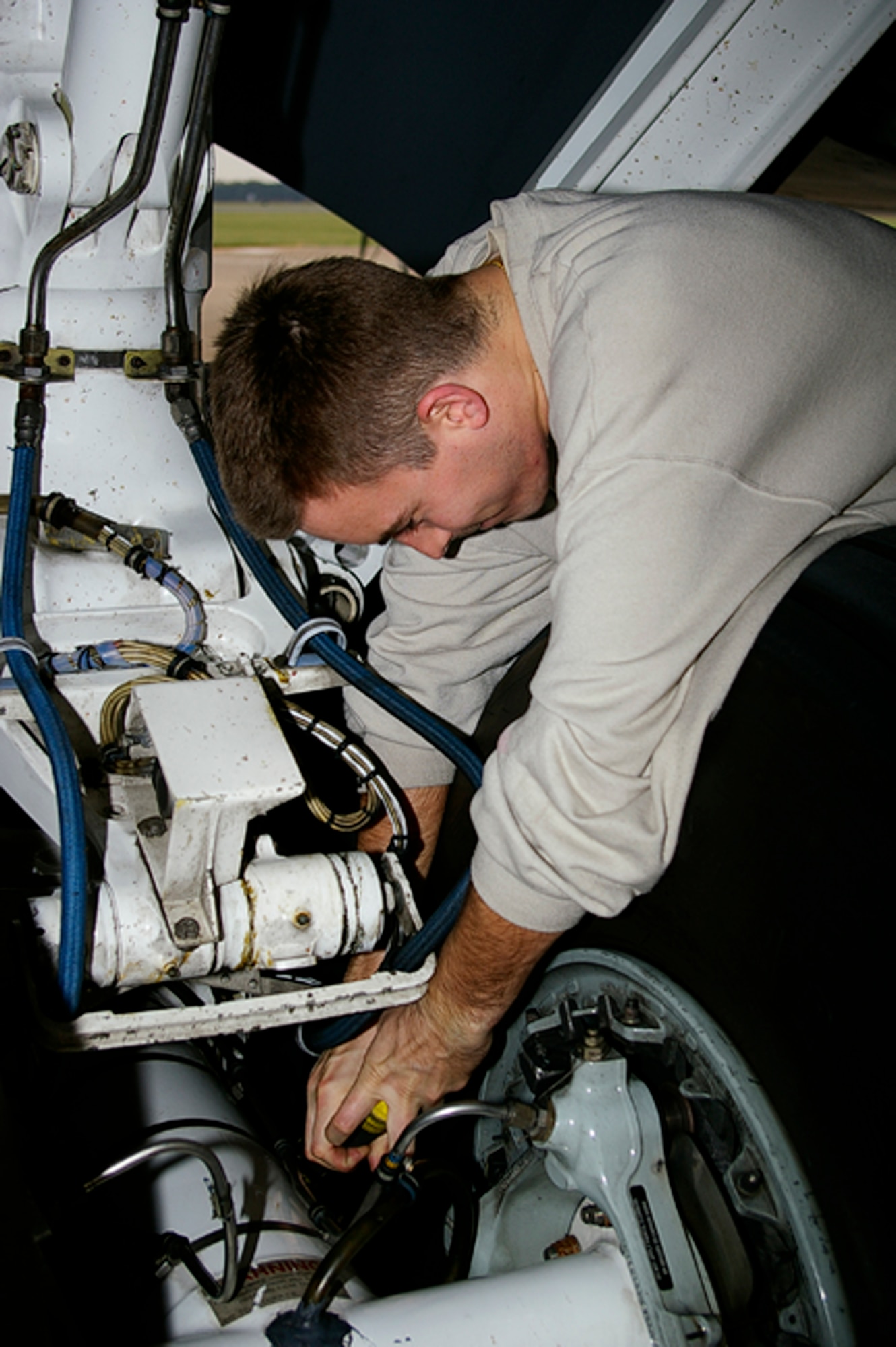 RAF Mildenhall, U.K. - Staff Sgt. Brandon Becker, 100th Aircraft Maintenance Squadron, inspects a KC-135R Stratotanker, ensuring the plane's brakes, suspension and tires are squared away before sending it on a black-letter initial flight. Black letters, as crew chiefs call them, occur when a plane flies a mission with zero write ups and is a testament to the skill and tenacity of the aircraft's crew chiefs. (U.S. Air Force photo by Karen Abeyasekere) 