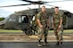 SAN ISIDRO AIR BASE, Dominican Republic -- Air Force Staff Sgts. David Pagani (left) and Robert Daly, Joint Task Force-Bravo Medical Element, with one of the two UH-60 Black Hawk helicopters they helped put together in the Dominican Republic.  JTF-Bravo deployed a team of 21 servicemembers to assist in relief efforts after Tropical Storm Noel pounded the small island nation.  (U.S. Air Force photo by Staff Sgt. Austin M. May)
