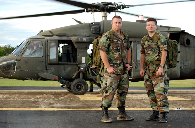 SAN ISIDRO AIR BASE, Dominican Republic -- Air Force Staff Sgts. David Pagani (left) and Robert Daly, Joint Task Force-Bravo Medical Element, with one of the two UH-60 Black Hawk helicopters they helped put together in the Dominican Republic.  JTF-Bravo deployed a team of 21 servicemembers to assist in relief efforts after Tropical Storm Noel pounded the small island nation.  (U.S. Air Force photo by Staff Sgt. Austin M. May)