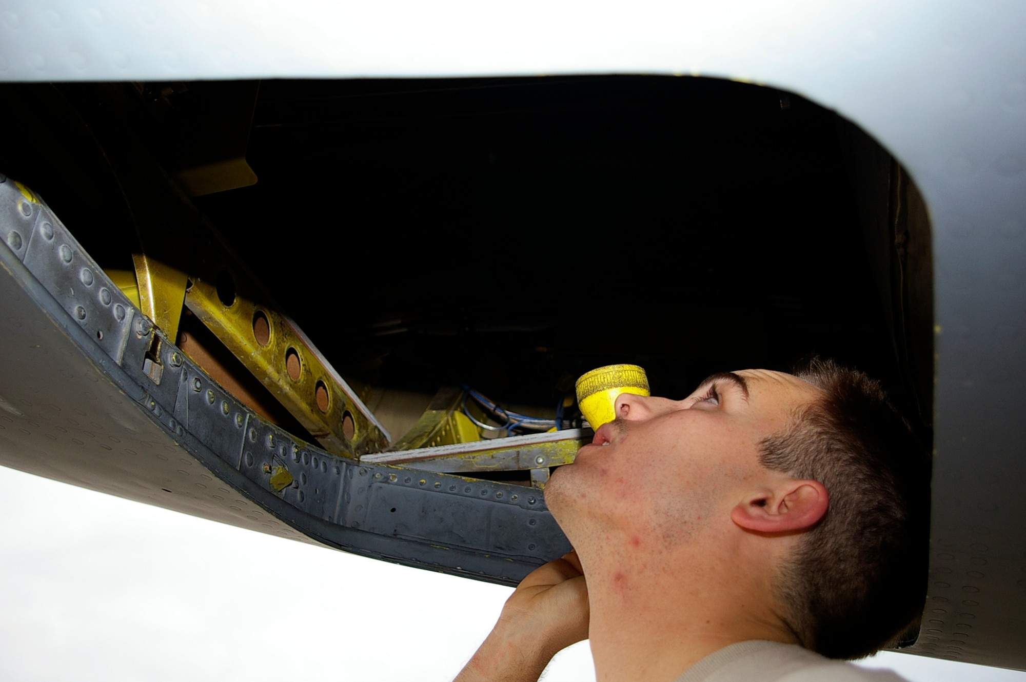 RAF Mildenhall, U.K. - Staff Sgt. Brandon Becker, 100th Aircraft Maintenance Squadron, performs a routine inspection on a KC-135R Stratotanker preceding its black-letter initial flight. Black letters, as crew chiefs call them, occur when a play flies a mission with zero write ups. (U.S. Air Force photo by Karen Abeyasekere) 