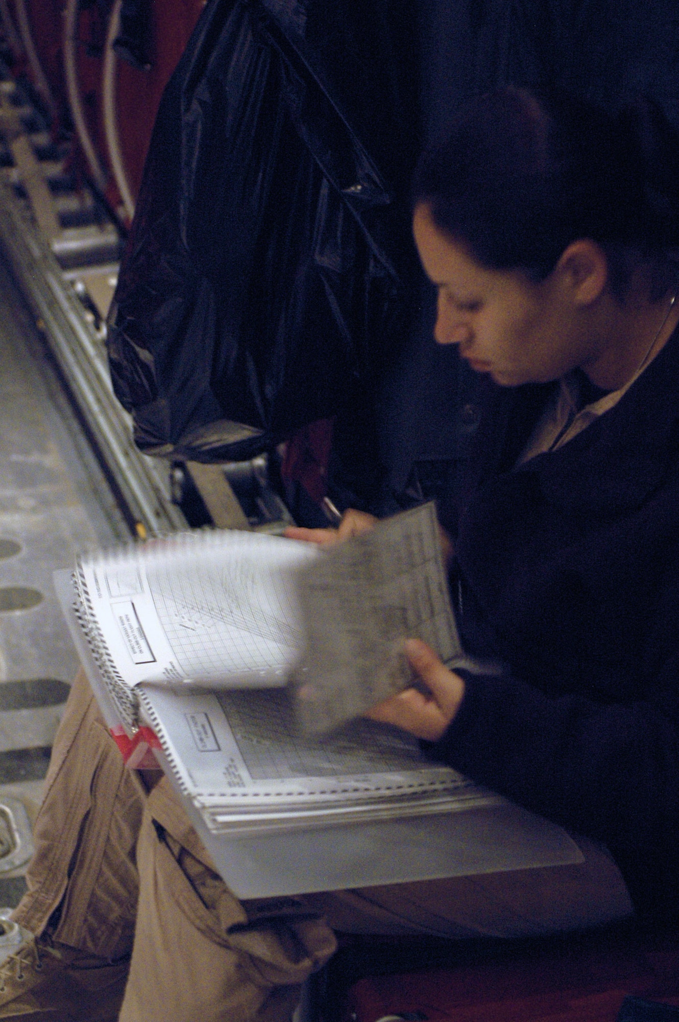 Staff Sgt. Amanda Murdock documents C-130 Hercules maintenance forms during a brief refueling stop in October in Southwest Asia. The aircraft crew dropped 300,000 leaflets over an area of Afghanistan. Sergeant Murdock is a 40th Expeditionary Airlift Squadron flight engineer. (U.S. Air Force photo/Staff Sgt. Jason Barebo) 

