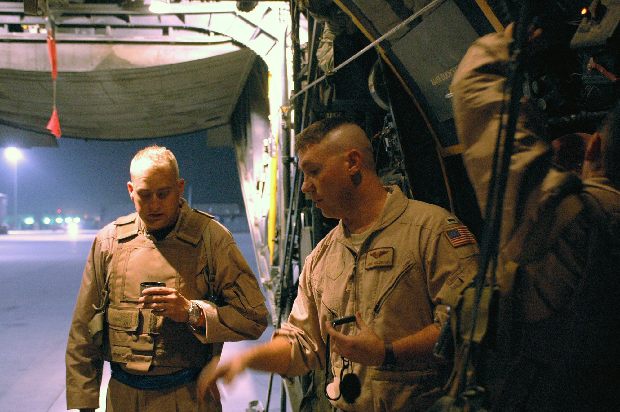 1st Lt. Jon Waldroup (right) discusses the leaflet drop mission details with Tech. Sgt. Kevin Letz in October at a base in Southwest Asia. The C-130 Hercules crew dropped 300,000 leaflets over an area of Afghanistan. Lieutenant Waldroup is a 40th Expeditionary Airlift Squadron navigator and Sergeant Letz is a 40th EAS loadmaster. (U.S. Air Force photo/Staff Sgt. Jason Barebo) 
