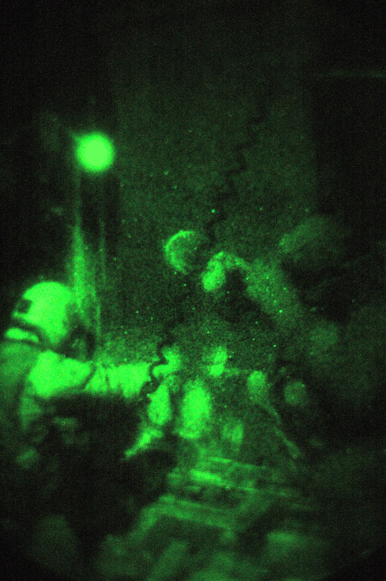 Airman 1st Class Jacob Medina (left) and Senior Airman William Moody throw boxes containing leaflets from a C-130 Hercules during a nighttime airdrop misison in October over Afghanistan. Airmen Medina and Moody are 40th Expeditionary Airlift Squadron loadmasters. The mission for the 40th EAS crew was to drop 300,000 leaflets over Afghanistan to give the local population a general warning to avoid the enemy. (U.S. Air Force photo/Staff Sgt. Jason Barebo) 
