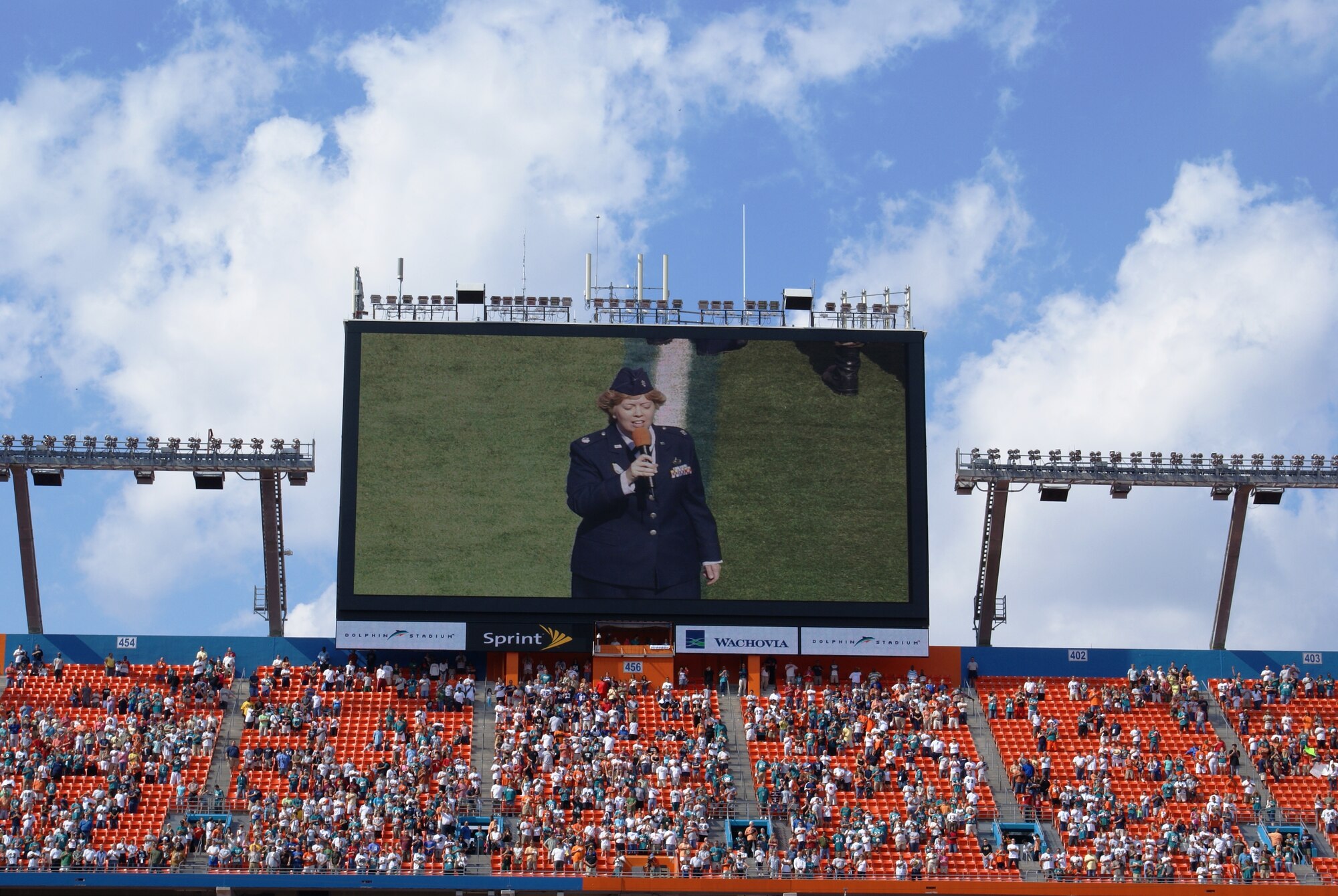U.S. Air Force Lt. Col. Deborah Crowder, U.S. Southern Command is shown singing the National Anthem on the giant video display at Dolphins Stadium Nov 11.  Colonel Crowder was part of a joint armed services Veterans Day celebration during the Miami Dolphins vs. Buffalo Bills pregame show.  The event sponsored by the Veterans Administration honored all past, present and future veterans. (U.S. Air Force photo/Tim Norton)