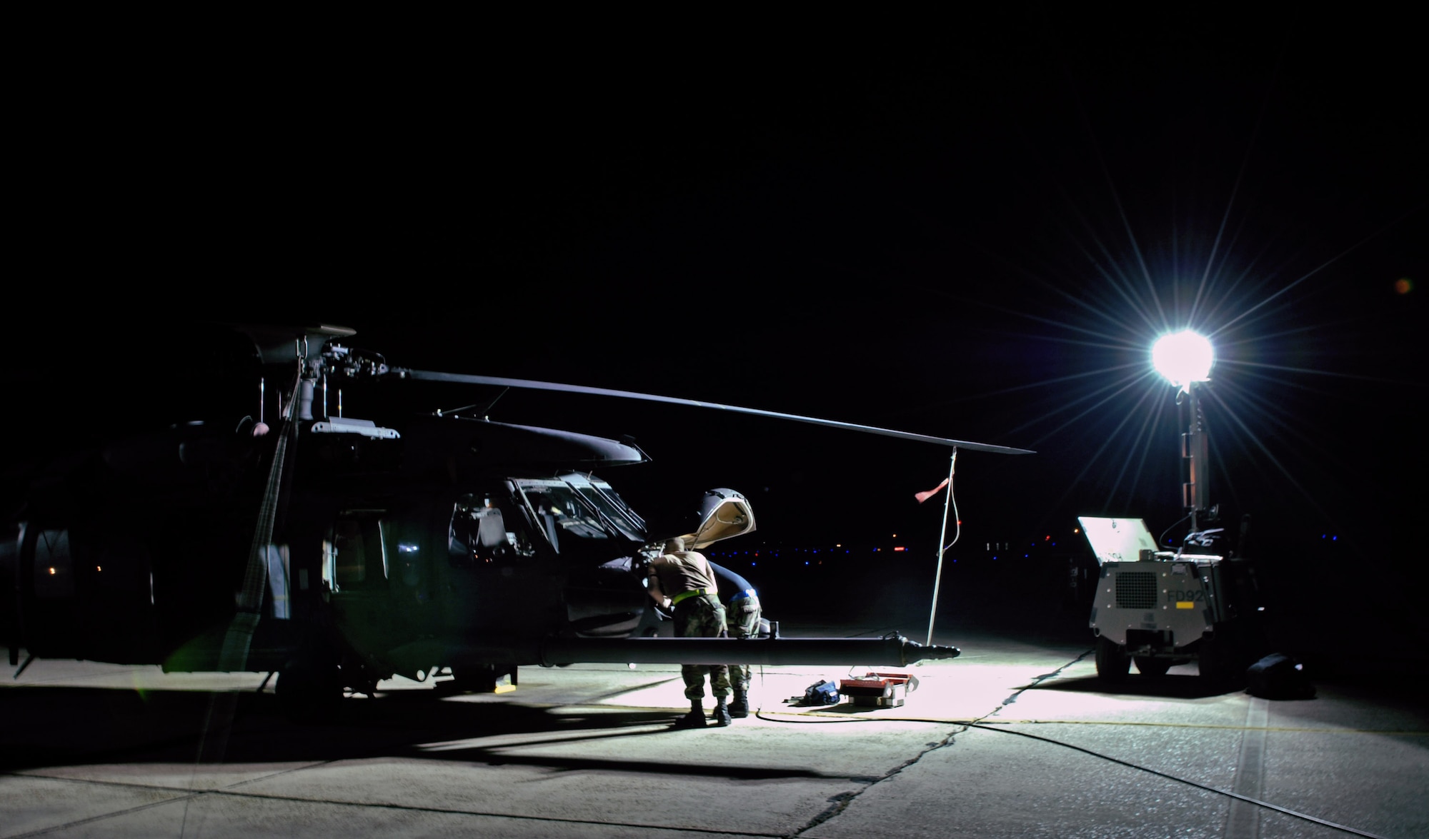 Senior Airman John Baia and Airman 1st Class Eric Dininger work on an HH-60G Pave Hawk helicopter Oct. 31 at Moody Air Force Base, Ga. Moody AFB Airmen work around the clock to ensure flight success of the aircraft. Airmen Baia and Diniger are assigned to the 23rd Equipment Maintenance Squadron. (U.S. Air Force photo/Senior Airman Elizabeth Rissmiller) 
